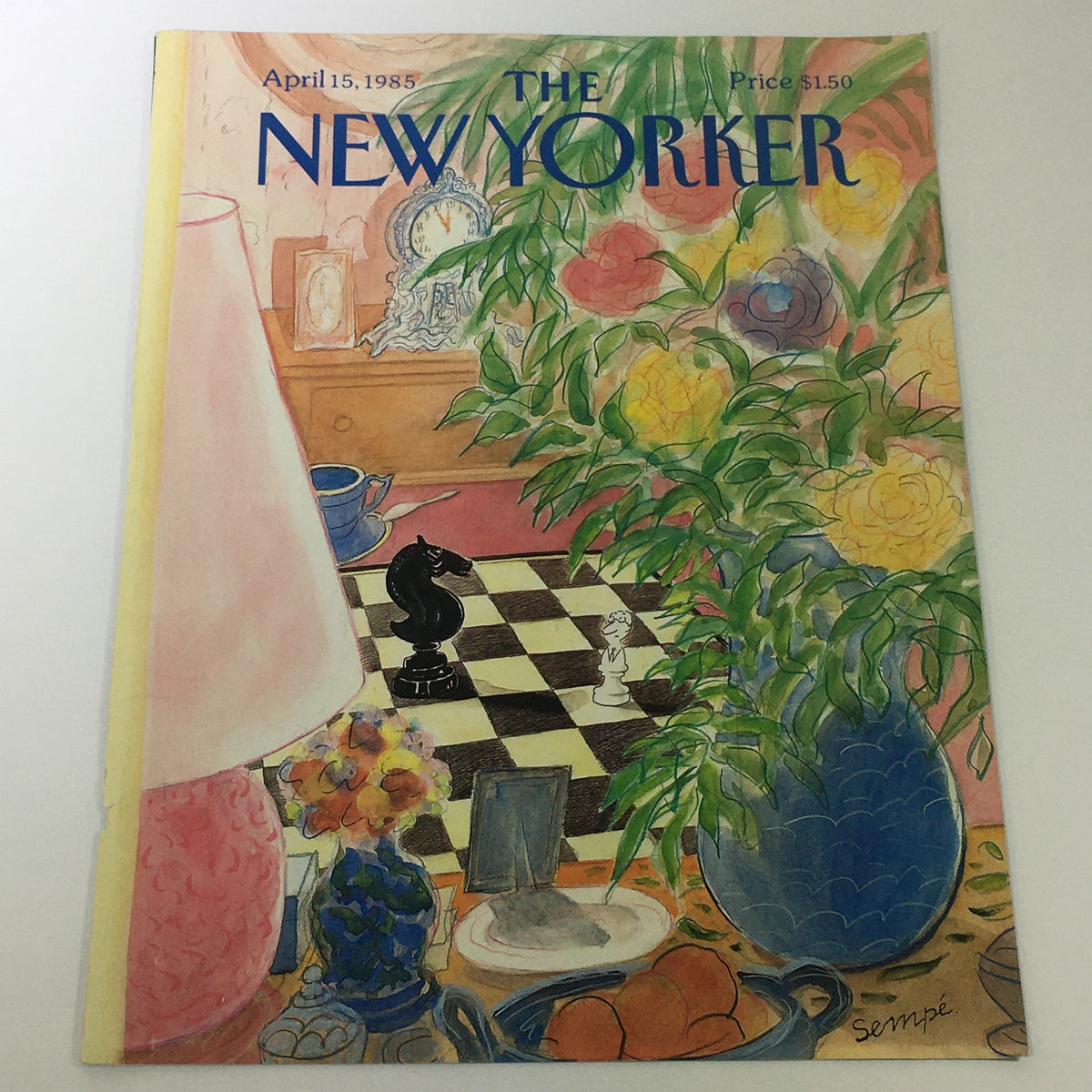 Cover of The New Yorker Magazine dated April 15, 1985, illustrated by Jean-Jacques Sempe. The cover features a chessboard, a lamp, flowers, and various decorative items, showcasing a vibrant home interior.