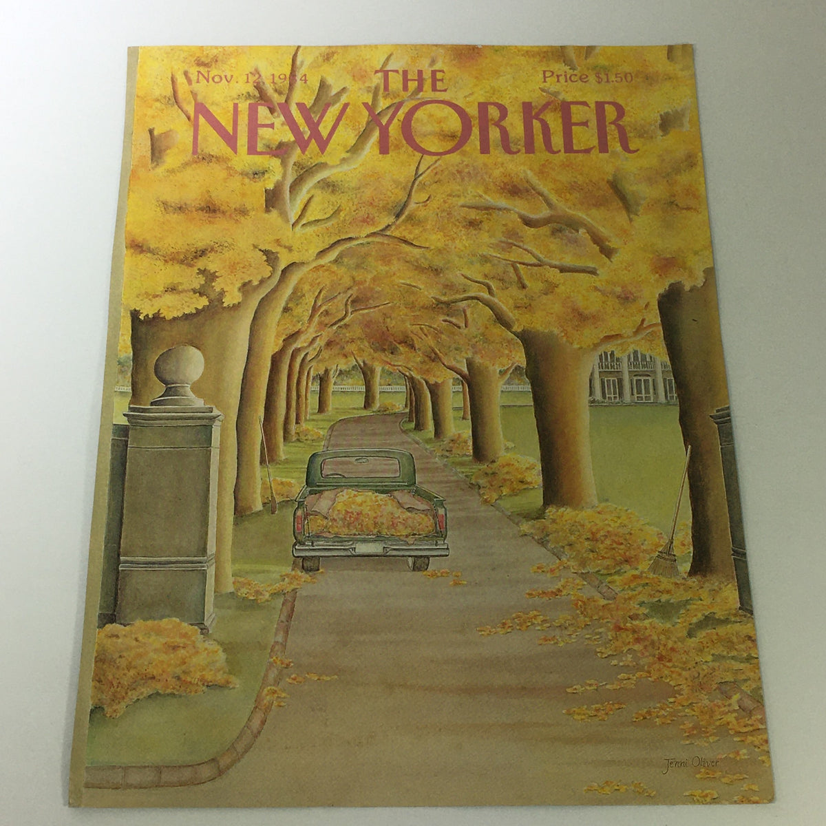 The New Yorker Magazine Cover - November 12 1984, featuring a picturesque autumn scene with a vintage car on a leaf-covered driveway lined by golden trees, illustrated by Jenni Oliver.