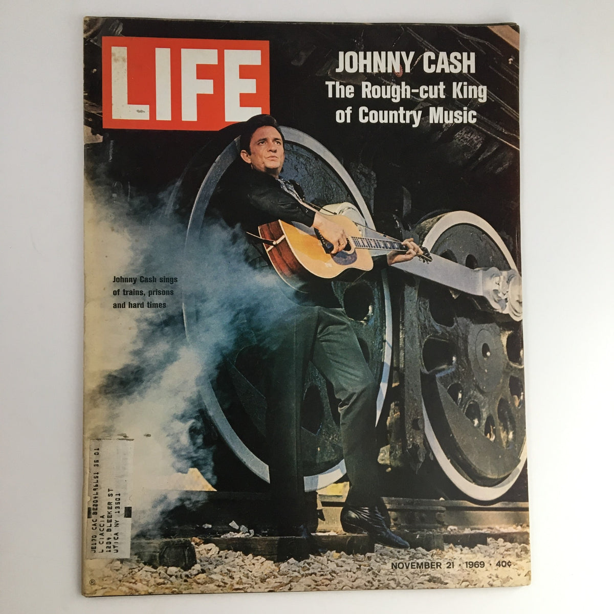 Life Magazine cover from November 21, 1969, featuring Johnny Cash, the Rough-Cut King of Country Music, standing with a guitar beside a vintage train backdrop. This iconic issue captures a pivotal moment in country music history.