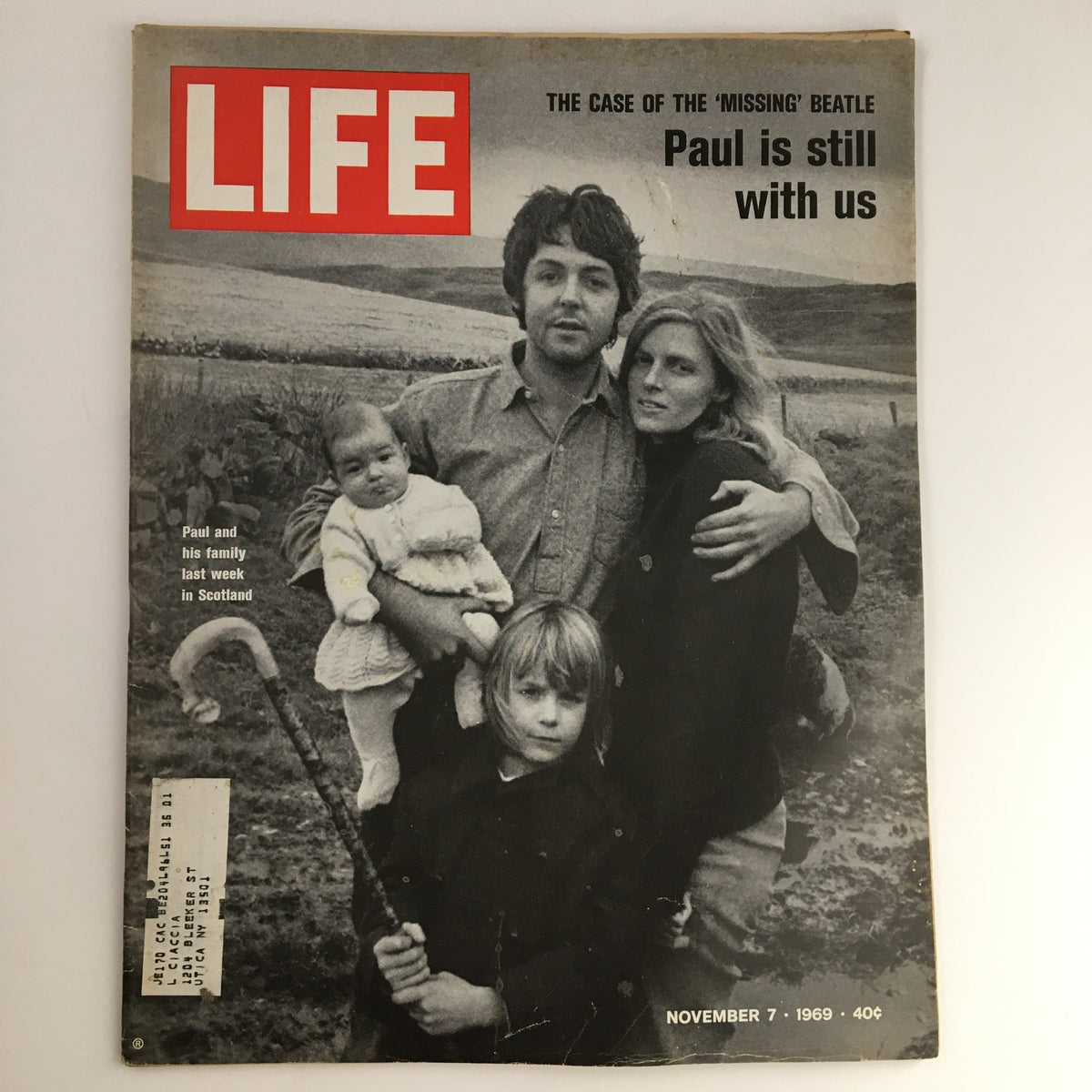 Life Magazine November 7 1969 featuring Paul McCartney and his family in Scotland, capturing a serene moment with Paul holding a child, surrounded by family amidst scenic landscapes.