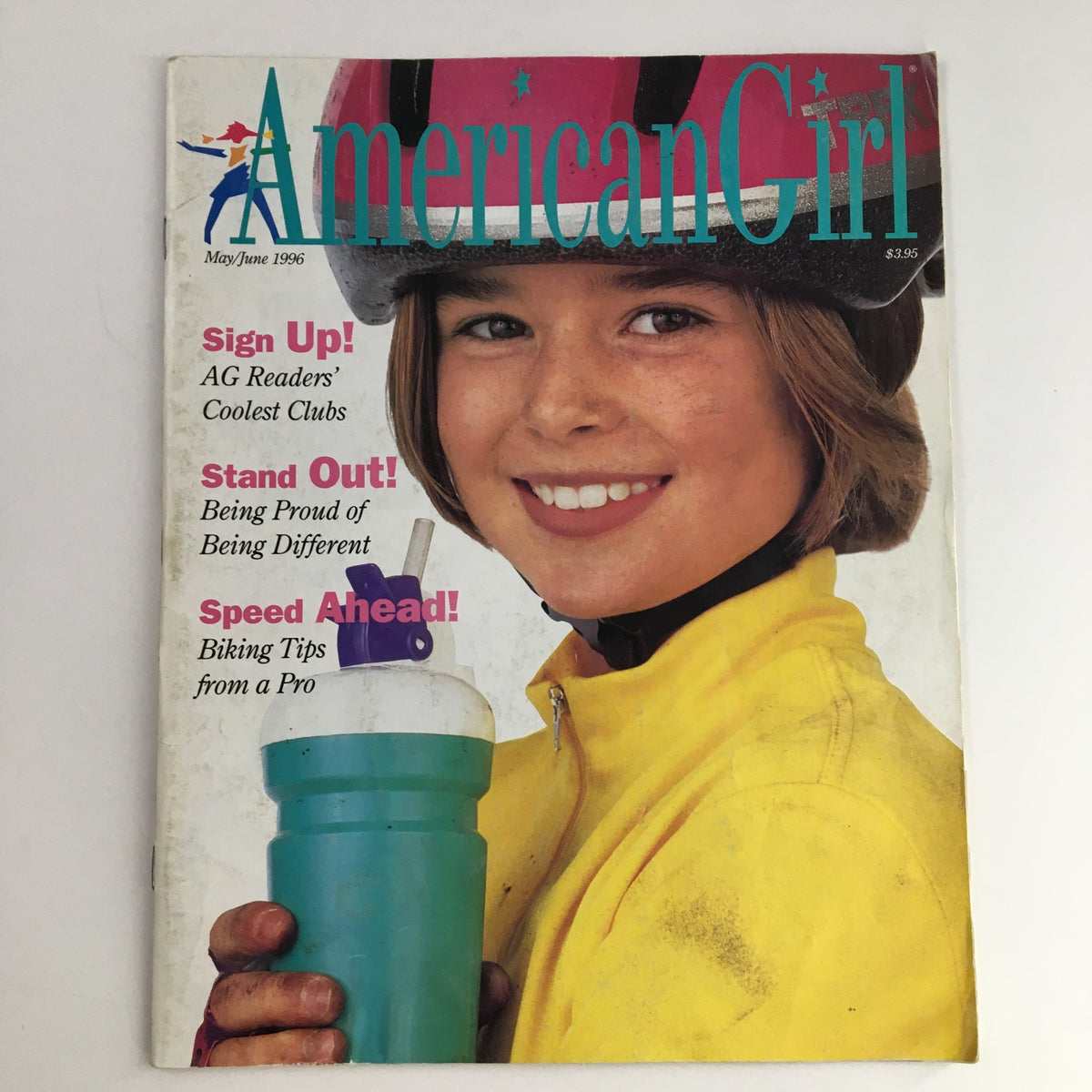 Cover of American Girl Magazine May 1996 featuring a happy girl wearing a helmet and holding a water bottle, highlighting the issue's theme of 'Speed Ahead! Biking Tips from A Pro.'