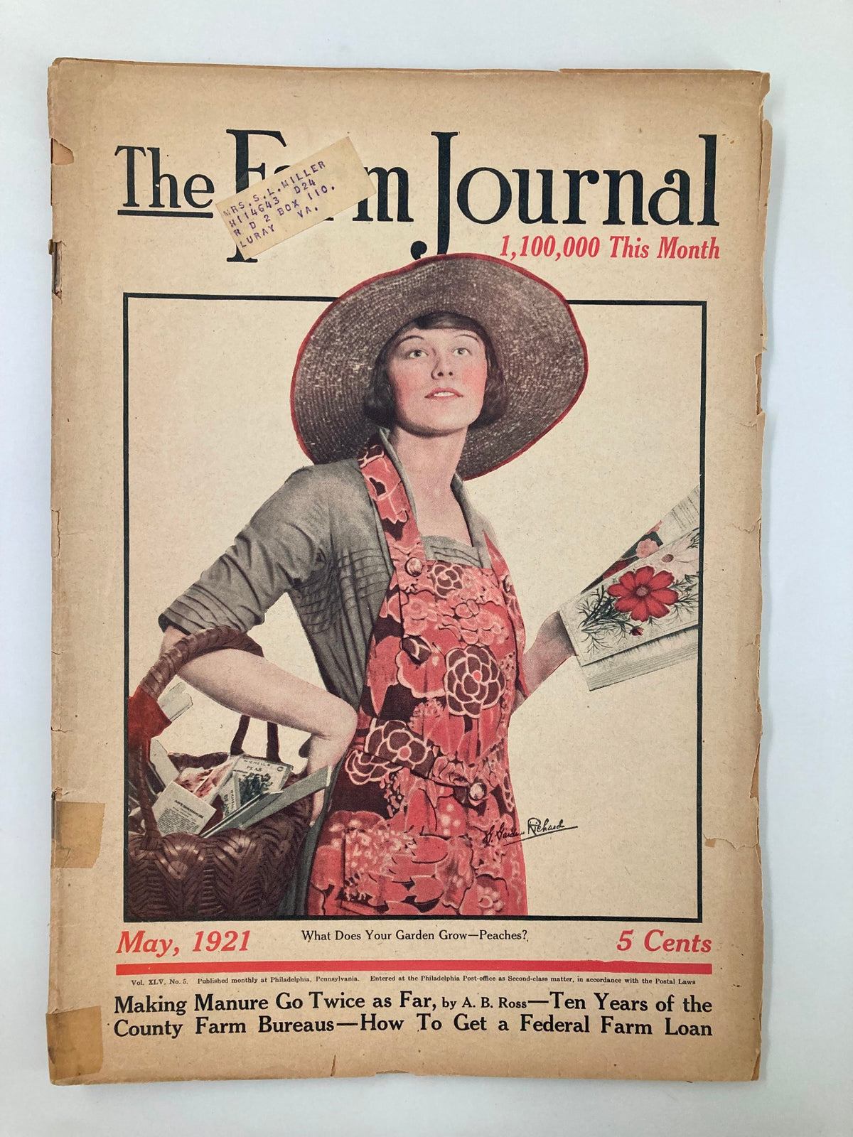Cover of The Farm Journal Magazine from May 1921, featuring a woman in a straw hat holding gardening supplies, emphasizing agricultural themes and federal farm loans.