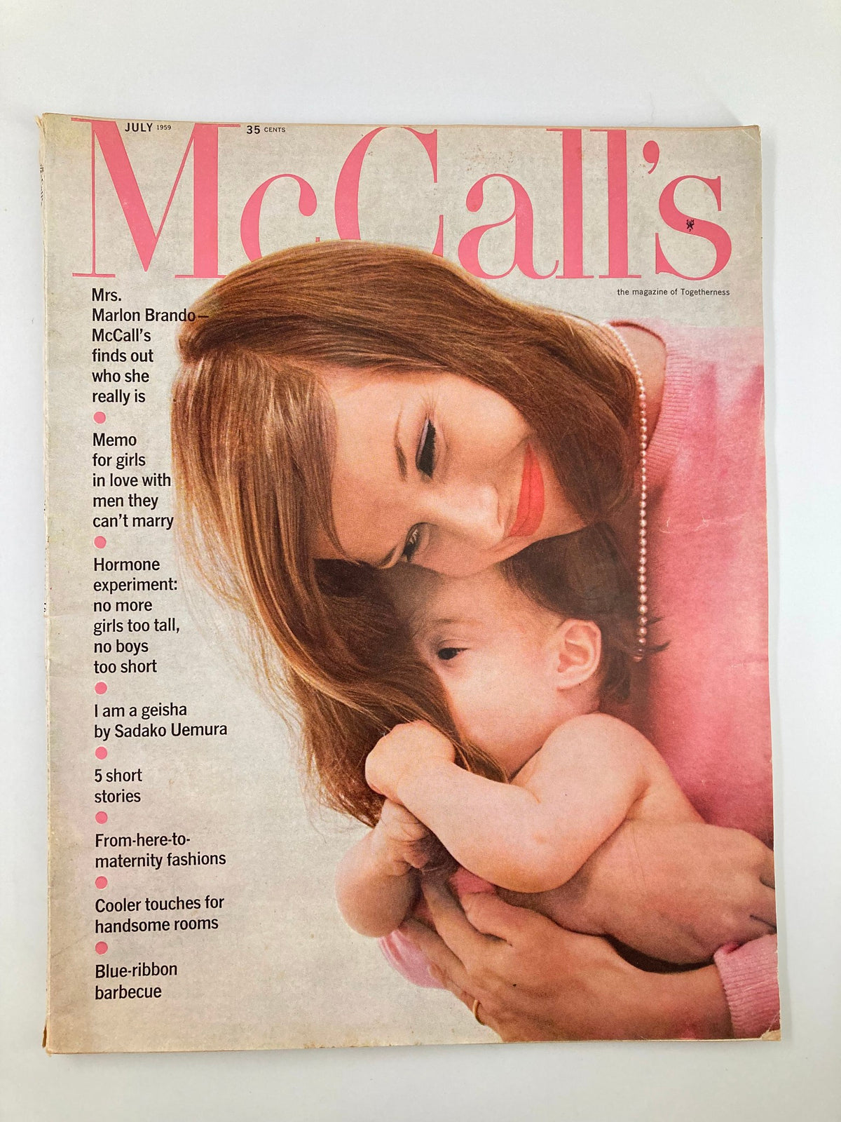 Vintage McCall's Magazine cover from July 1959, Volume 86, Issue 10 featuring a woman and child, showcasing the title 'One Girl at a Time'.