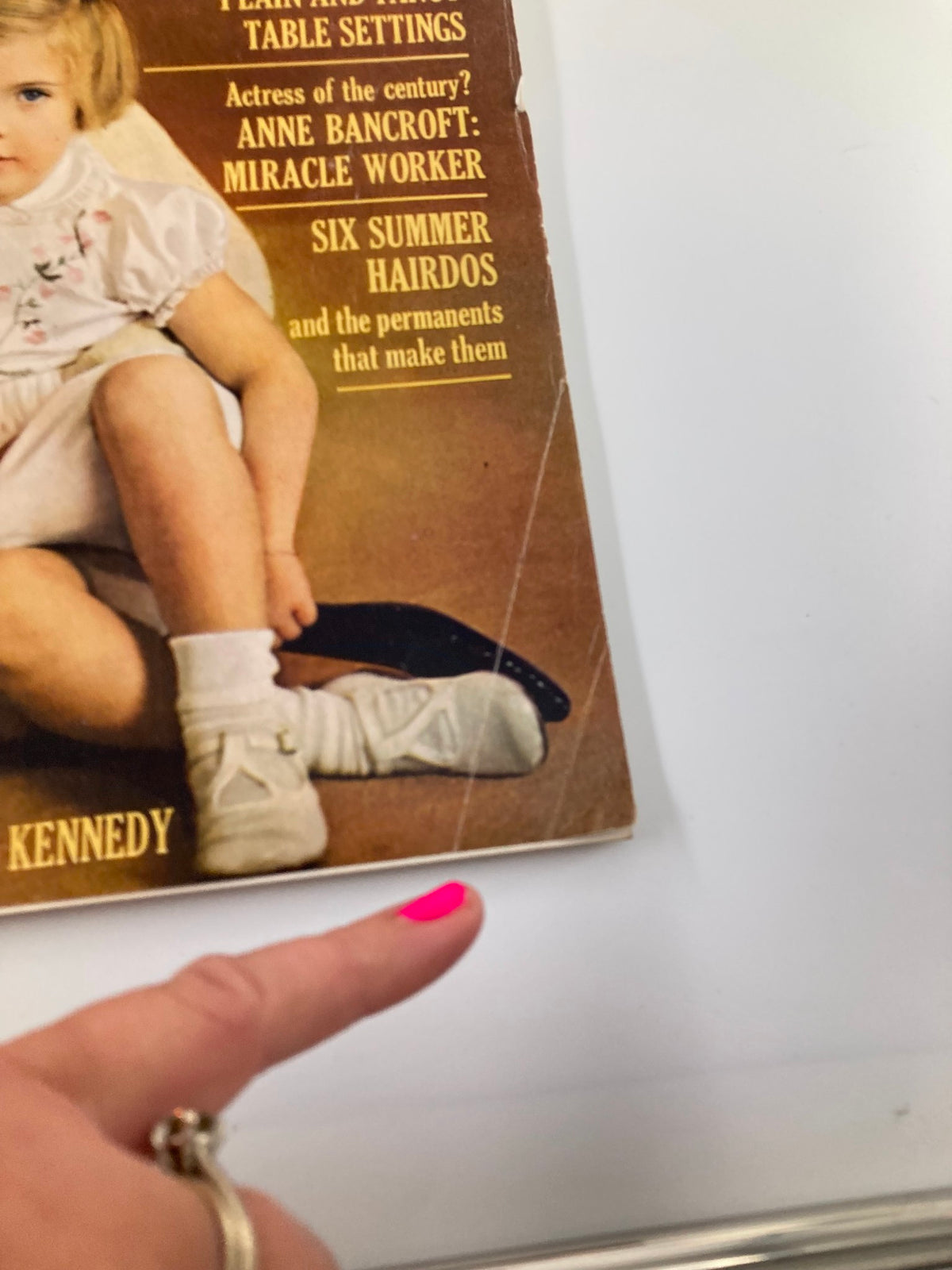 Close-up of the VTG McCall's Magazine May 1962 showing the lower corner with text about featured articles, including 'Anne Bancroft: Miracle Worker' and 'Six Summer Hairdos'.