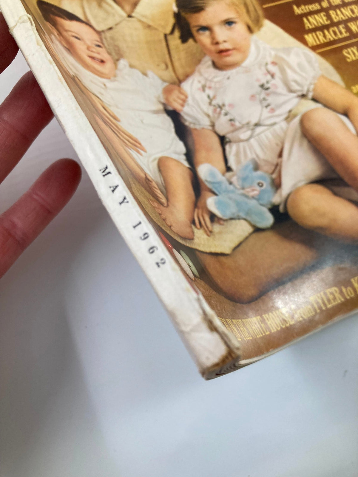 Close-up view of the spine of the VTG McCall's Magazine May 1962, featuring 'MAY 1962' printed on the edge, showcasing the magazine's vintage character.