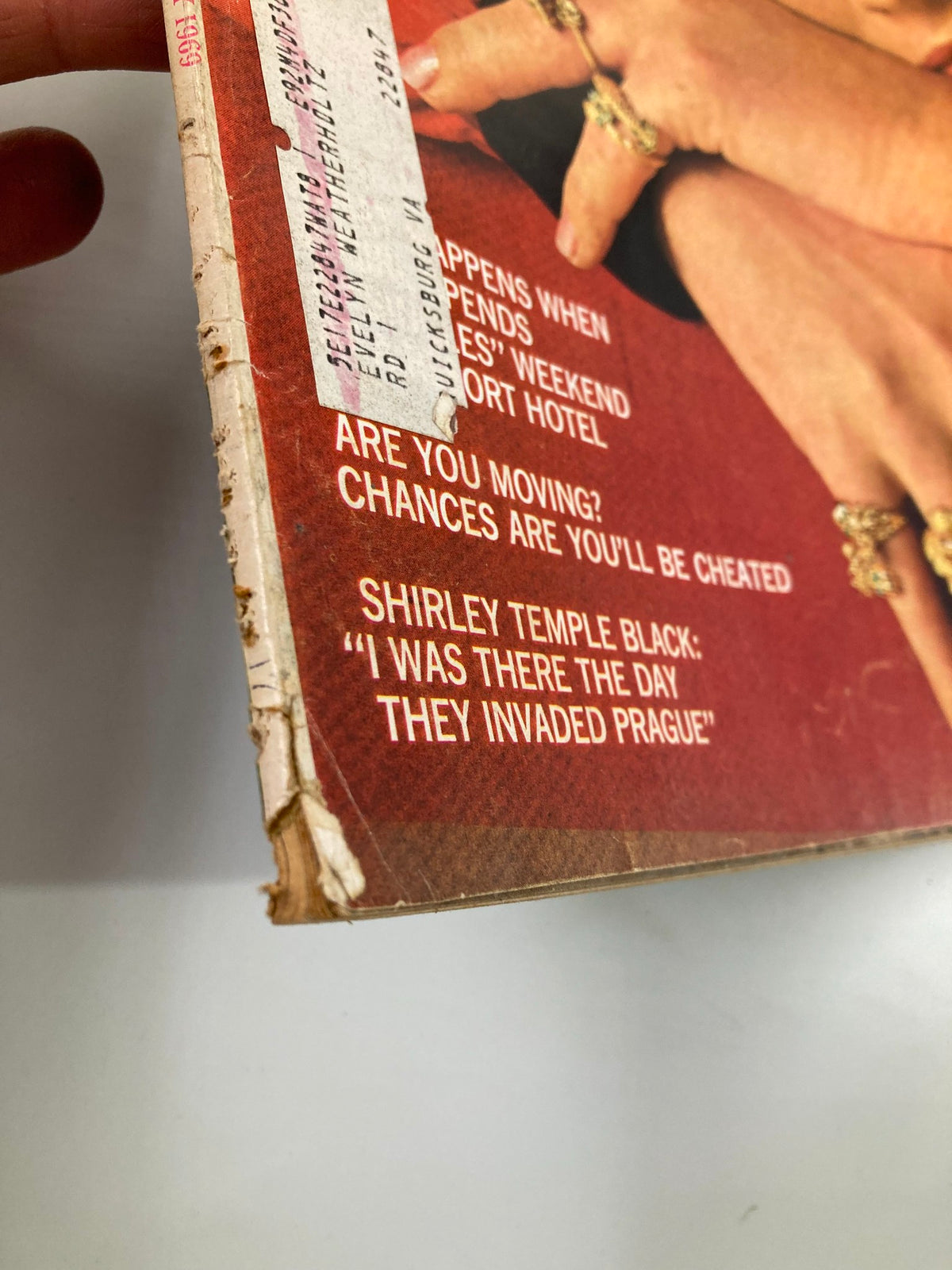 Side view of the spine of VTG McCall's Magazine January 1969 with visible wear and a label, illustrating its historical authenticity.