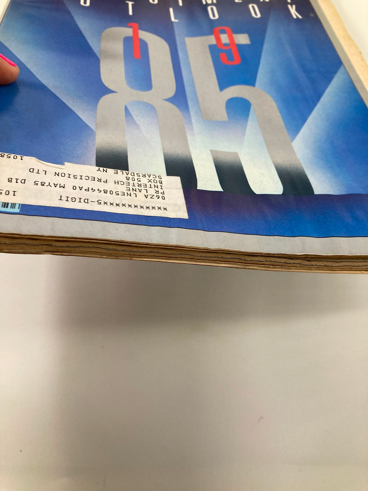Side view of the VTG Business Week Magazine December 31 1984 titled 'Investment Outlook: Untamed Budget', highlighting its vintage condition with aged paper and a front label.