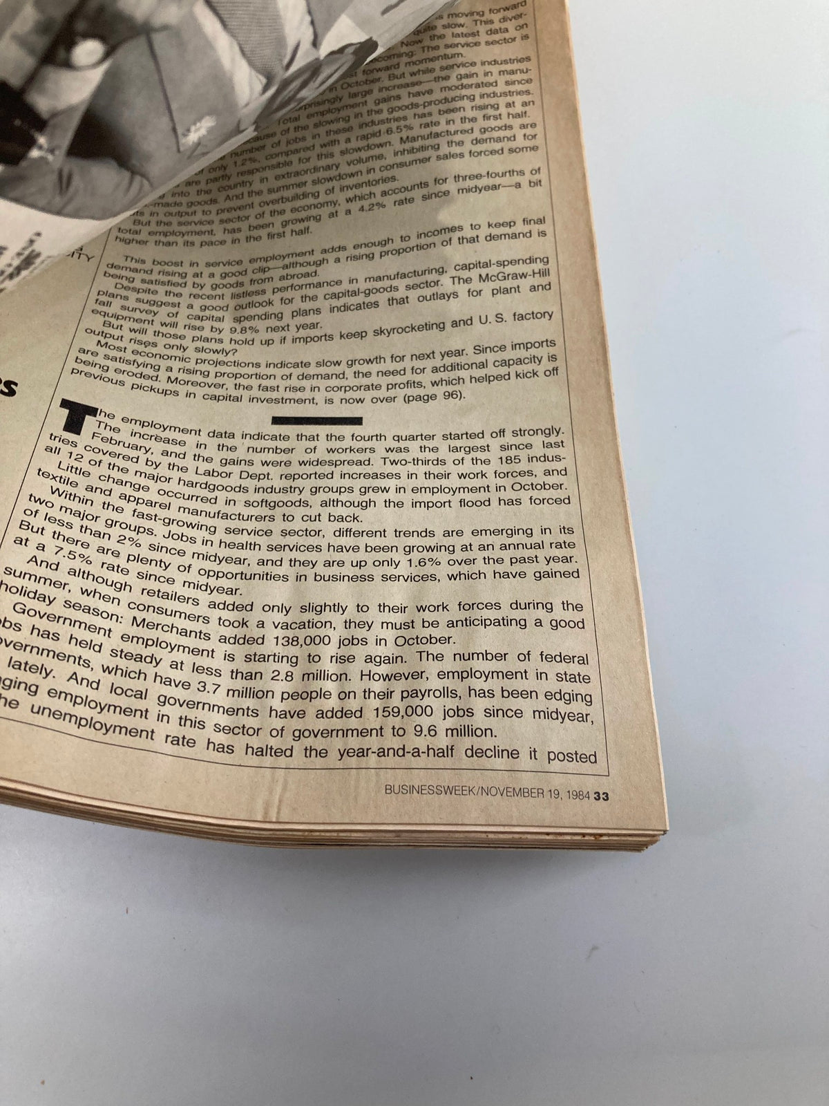 Close-up view of a page from the VTG Business Week Magazine, November 19, 1984, featuring the text discussing economic trends and employment statistics during the Ronald Reagan era, part of the 'Chapter Two' exploration.