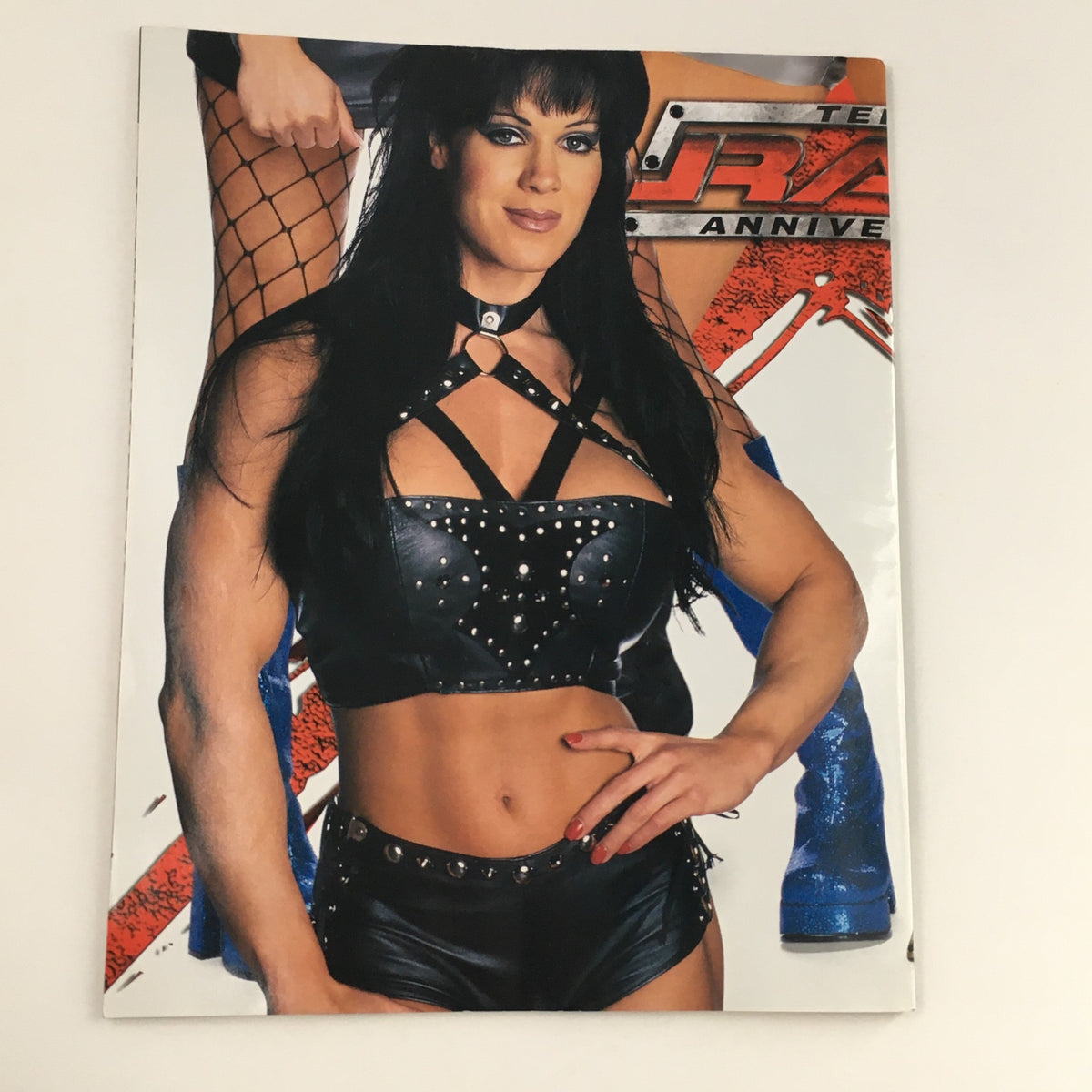 Cover of WWE Raw Magazine Holiday 2002 featuring a glamorous image of iconic female wrestler Chyna, emphasizing the magazine's focus on legendary wrestlers.