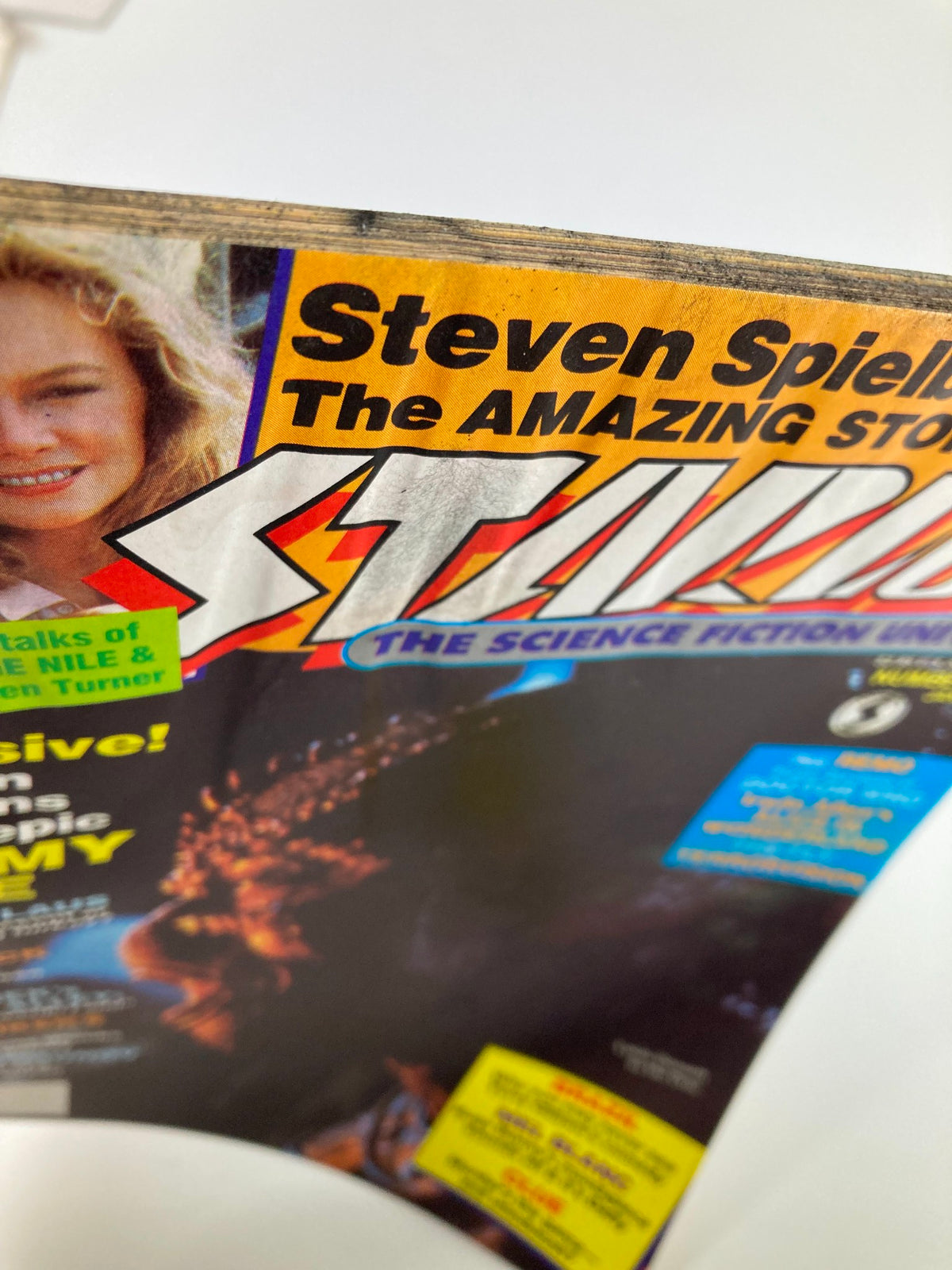 Close-up view of the cover of VTG Starlog Magazine January 1986 #102, showcasing bold graphics and notable mentions of Steven Spielberg and alien-themed features.