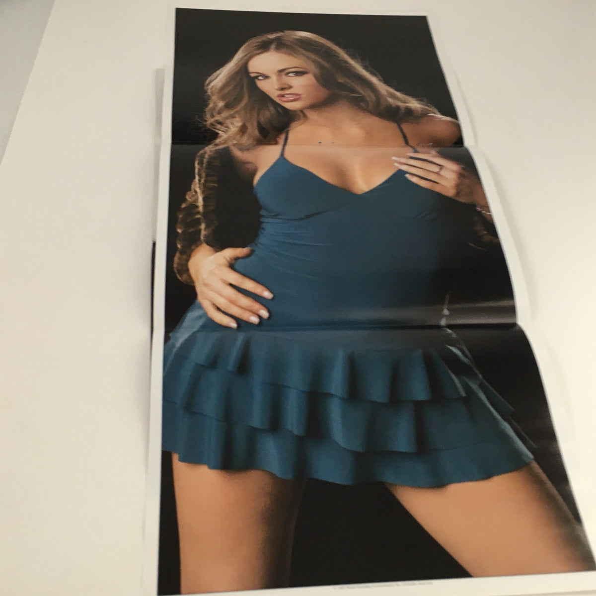 Poster from WWE Raw Magazine February 2005 featuring a model in a blue dress, highlighting the vibrant visuals included in this collectible wrestling issue.