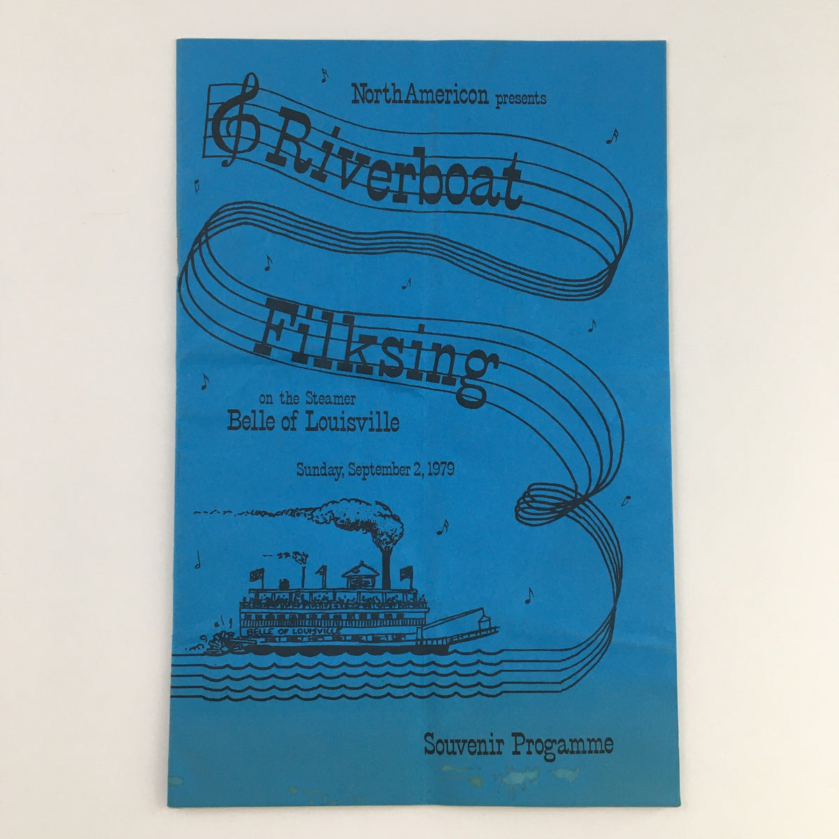 North American Presents September 1979 Riverboat Filksing Souvenir Programme front cover featuring a colorful illustration of the Belle of Louisville on a river with musical notes.