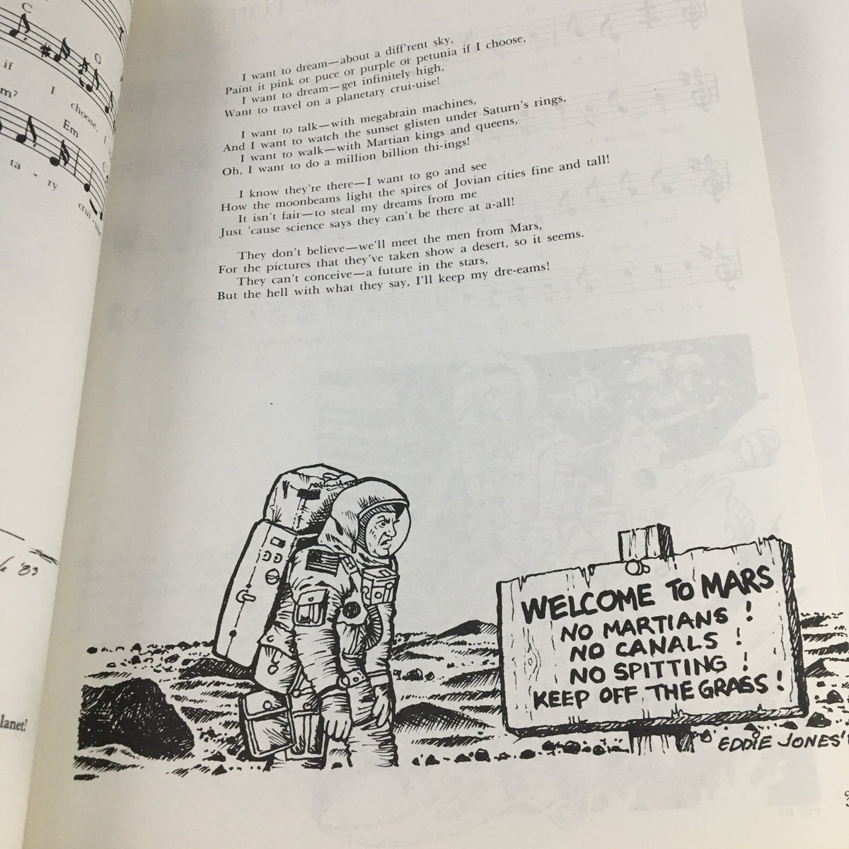 Another interior page from 1988 A New Settlement of Old Scores by John Brunner, highlighting lyrics and musical notation with a humorous illustration of an astronaut in front of a sign labeled 'Welcome to Mars'.