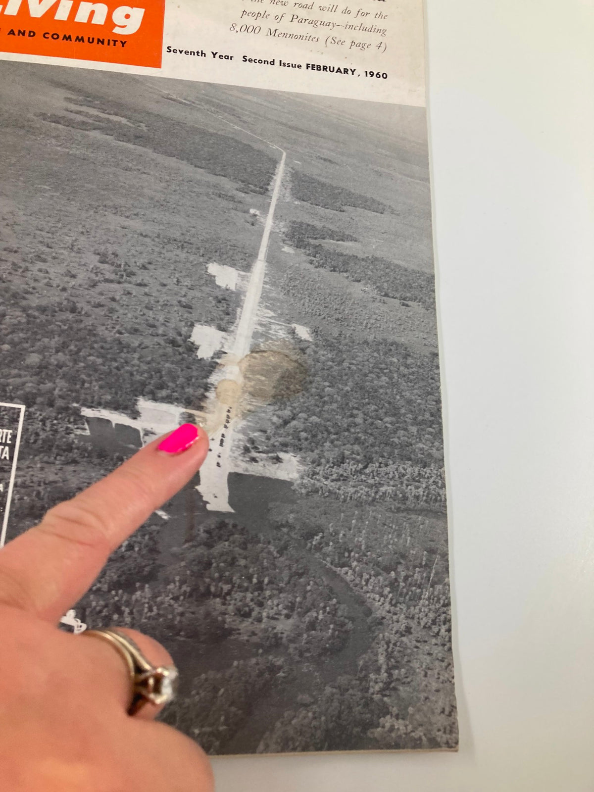Cover of VTG Christian Living Magazine February 1960 highlighting The Trans-Chaco Road in Paraguay. Image features an aerial view of the road with a finger pointing at it, emphasizing the article's focus on travel in Paraguay.