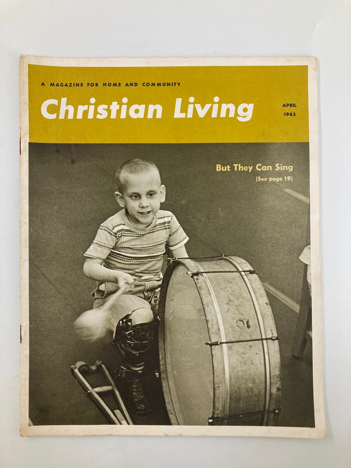 Cover of VTG Christian Living Magazine April 1963 featuring a boy playing a bass drum, highlighting nostalgic themes and vintage charm.