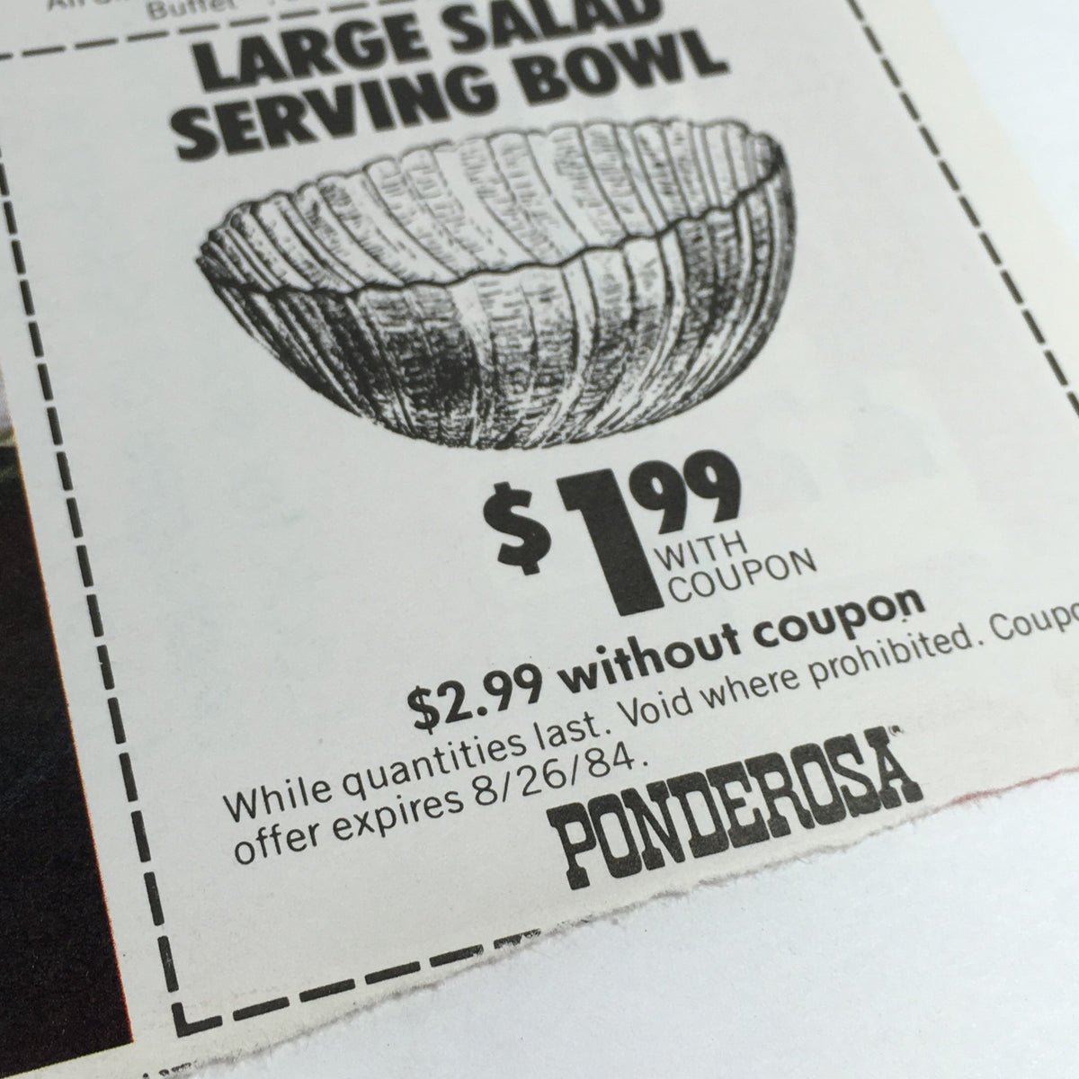 Close-up of Ponderosa salad bowl coupon from 1984, highlighting discount details and expiration date.