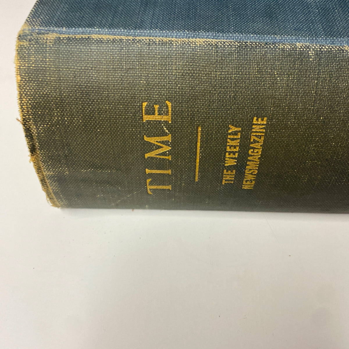 Close-up view of the spine of Time Magazine Bound Weekly July 7, 1930 - December 29, 1930, featuring worn edges and gold lettering.