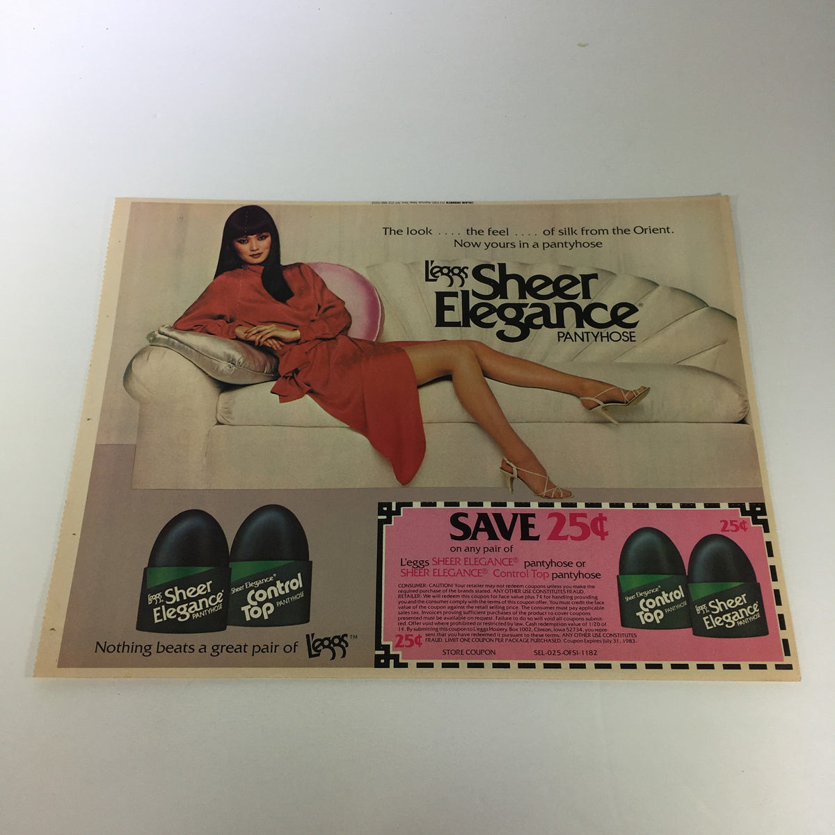 VTG Retro 1983 Leggs Sheer Elegance Pantyhose print advertisement highlighting a stylish model in a red dress, featuring a coupon saving 25 cents on Leggs pantyhose with eye-catching visuals and promotional messaging.