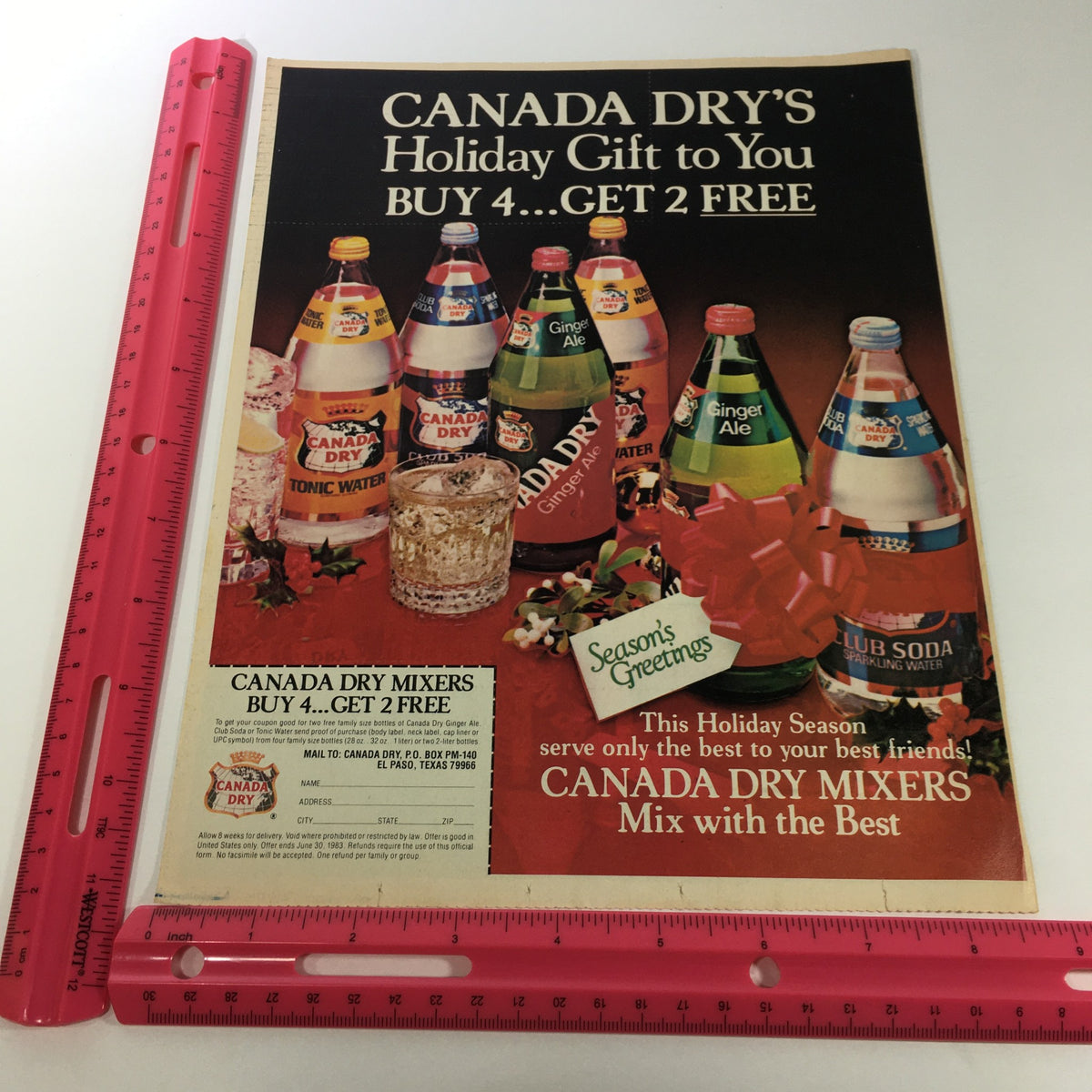 1983 Canada Dry advertisement showcasing various Canada Dry Mixers with a Buy 4 Get 2 FREE promotion. The colorful display features bottles of Ginger Ale, Tonic Water, and Club Soda, encapsulating the holiday spirit. Related to VTG Retro 1983 Canada Dry Mixers Sparkling Water Buy 4 Get 2 FREE Ad Coupon.