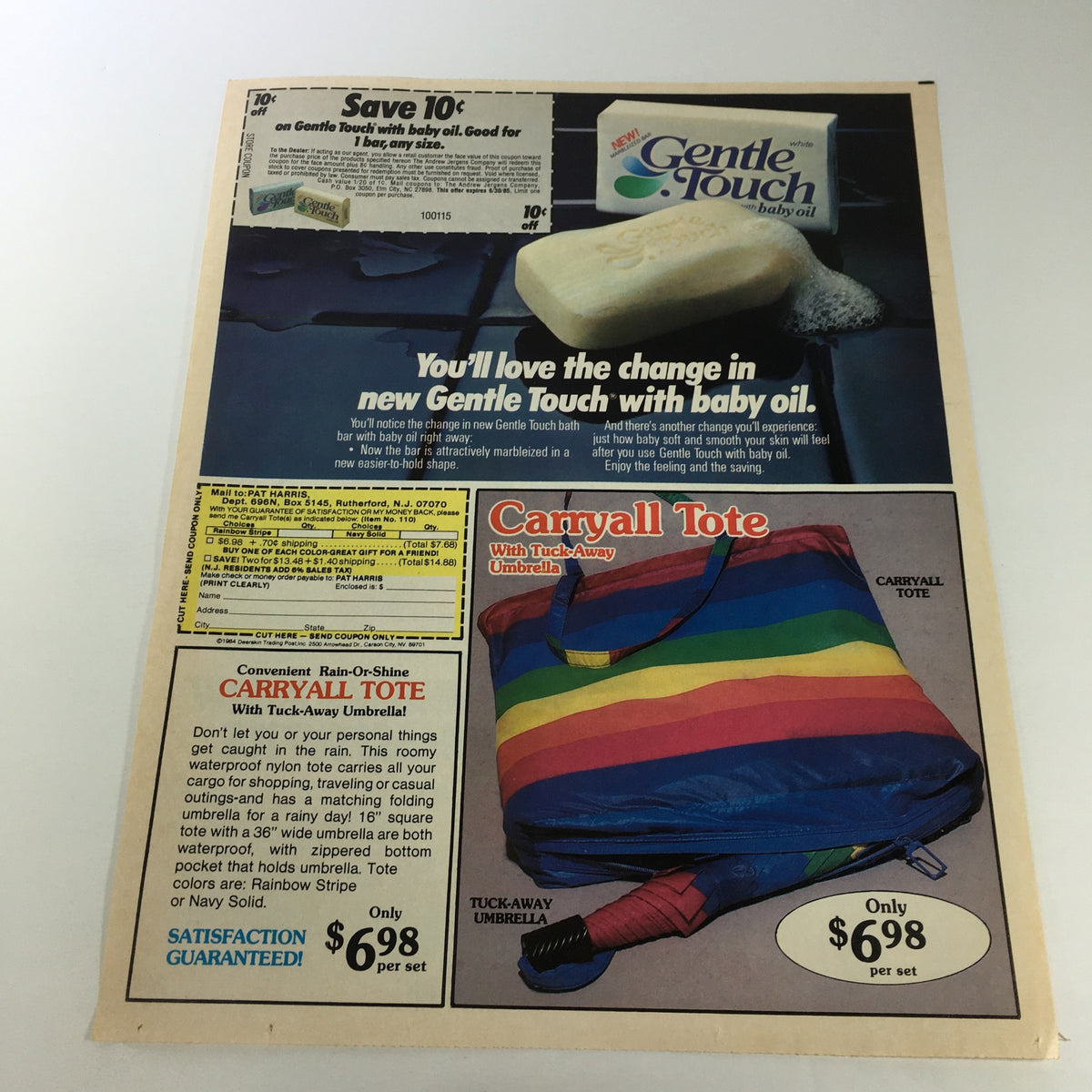 VTG Retro 1985 advertisement for Gentle Touch baby oil and Carryall Tote umbrella, showcasing gentle care and convenience with colorful products and prices.