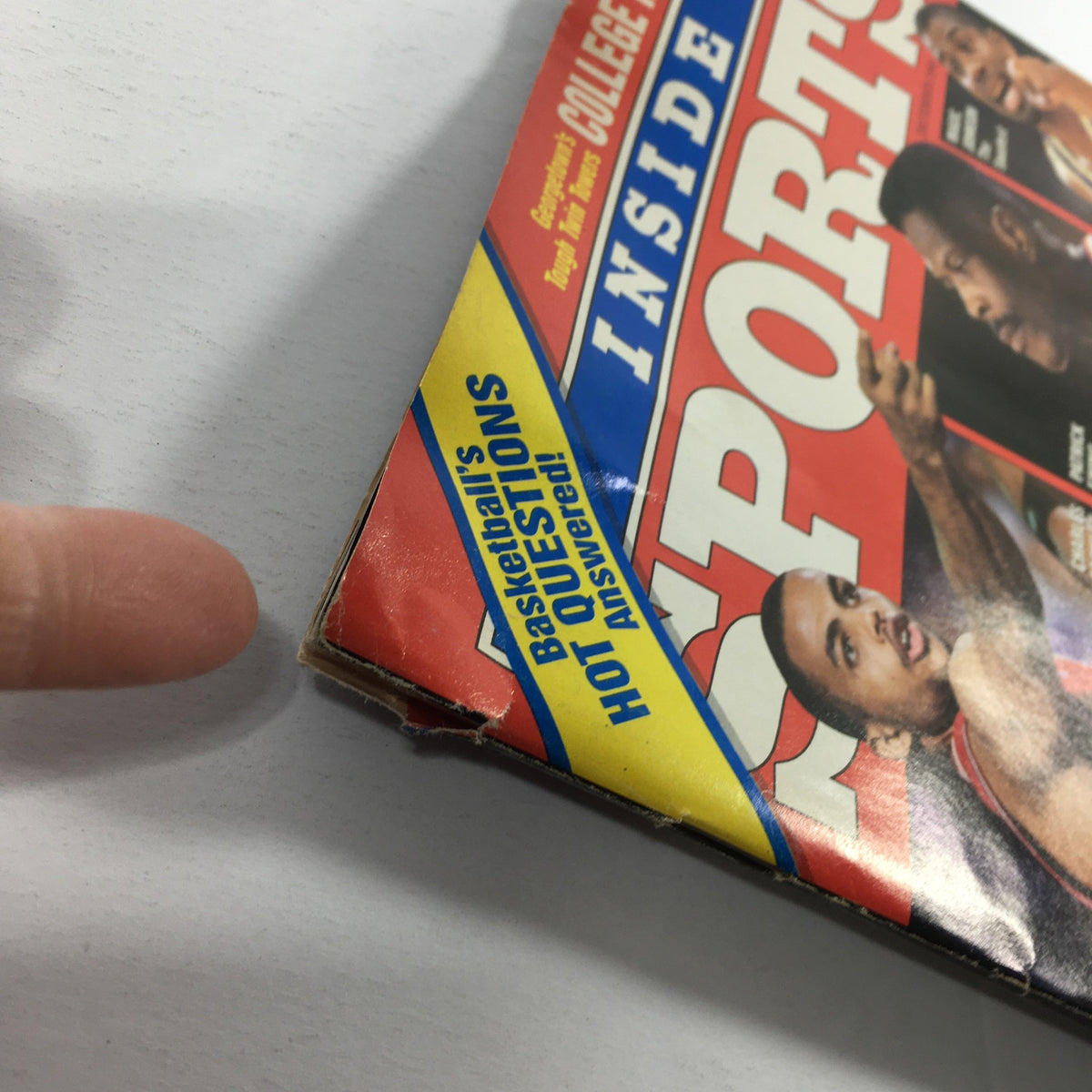 Close-up of Inside Sports Magazine December 1990, highlighting the corner and binding condition, featuring questions about basketball superstars, including Michael Jordan.