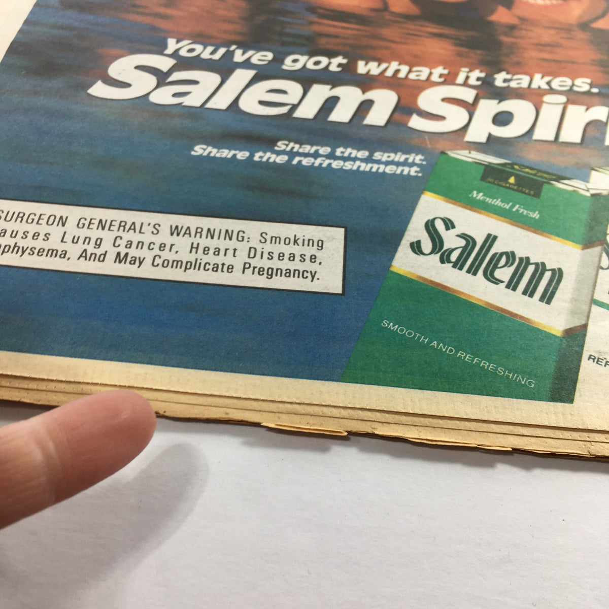 Close-up of a vintage Salem cigarettes advertisement showing the Surgeon General's warning and packaging details. The ad promotes 'Share the spirit. Share the refreshment' along with the slogan 'You've got what it takes. Salem Spirit.' from The Sporting News, September 1, 1966.