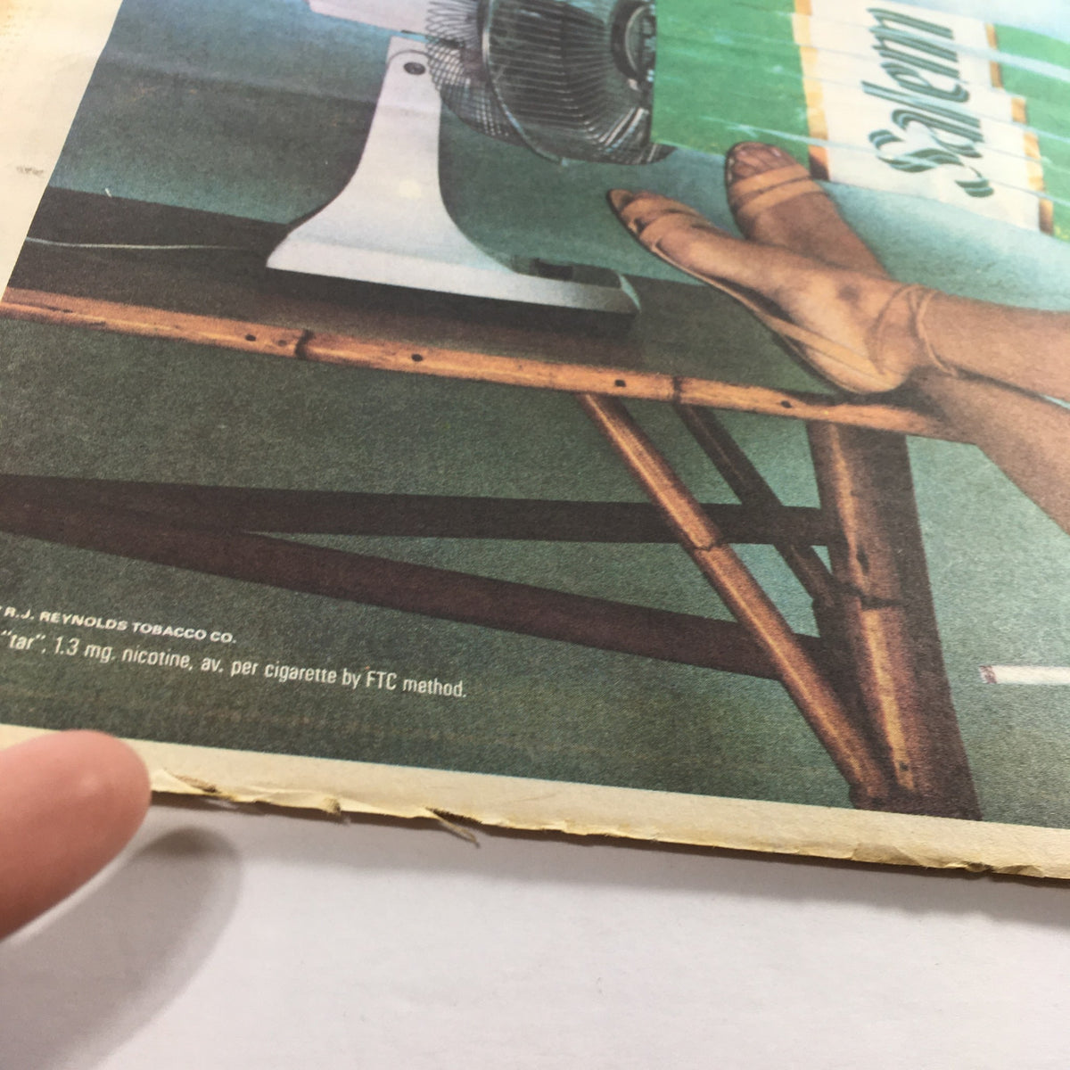 Close-up of a vintage advertisement in VTG The Sporting News April 27 1987, showing a fan and legs with Salem cigarettes branding.