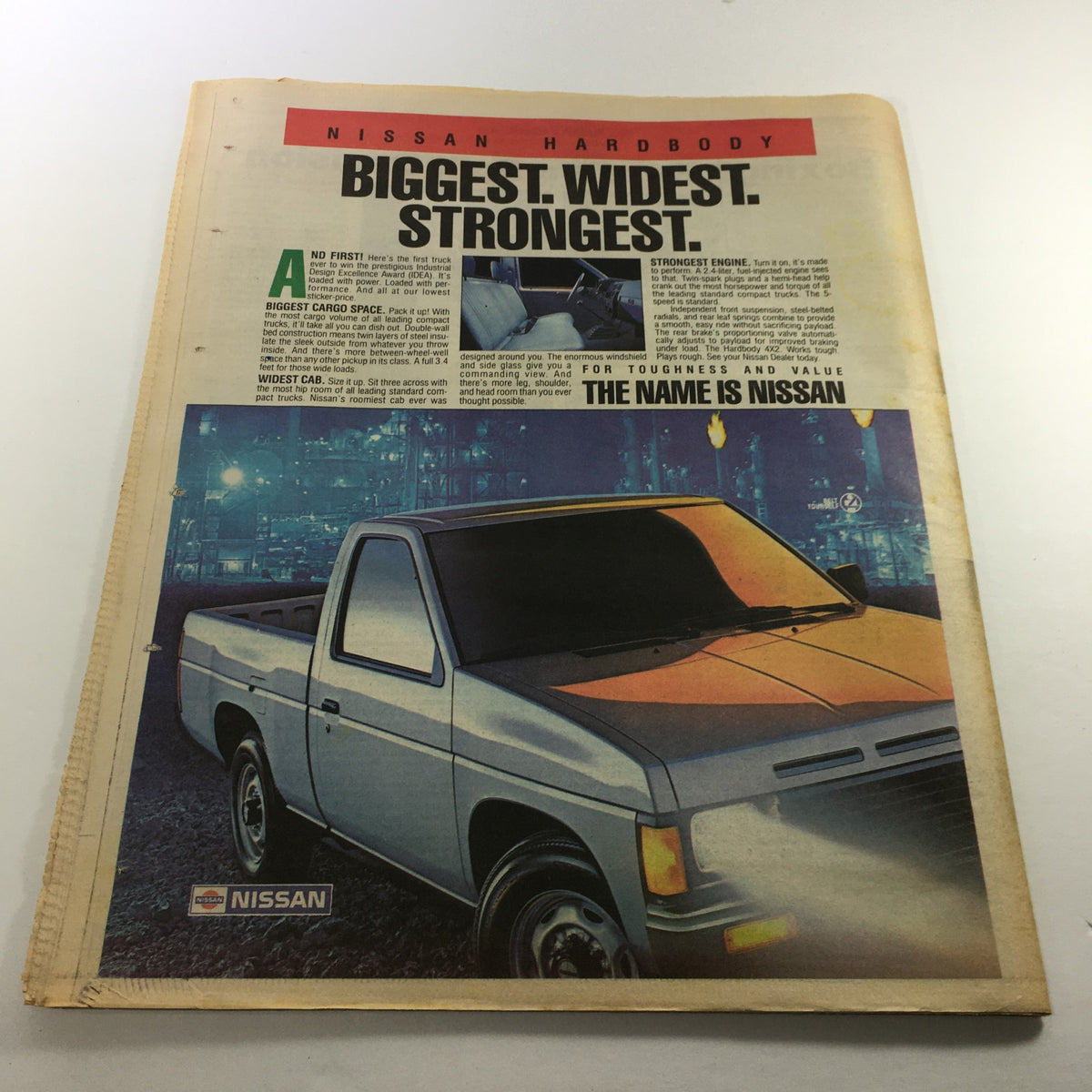 Advertisement from VTG The Sporting News December 8 1986 for Nissan Hardbody trucks highlighting their size and strength.