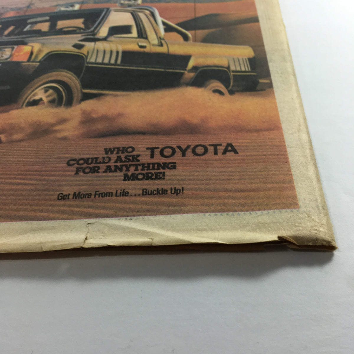 Close-up of Toyota 4x4 Turbo advertisement in VTG The Sporting News May 18 1987, featuring a stylish truck in the desert and the tagline promoting Toyota's quality.