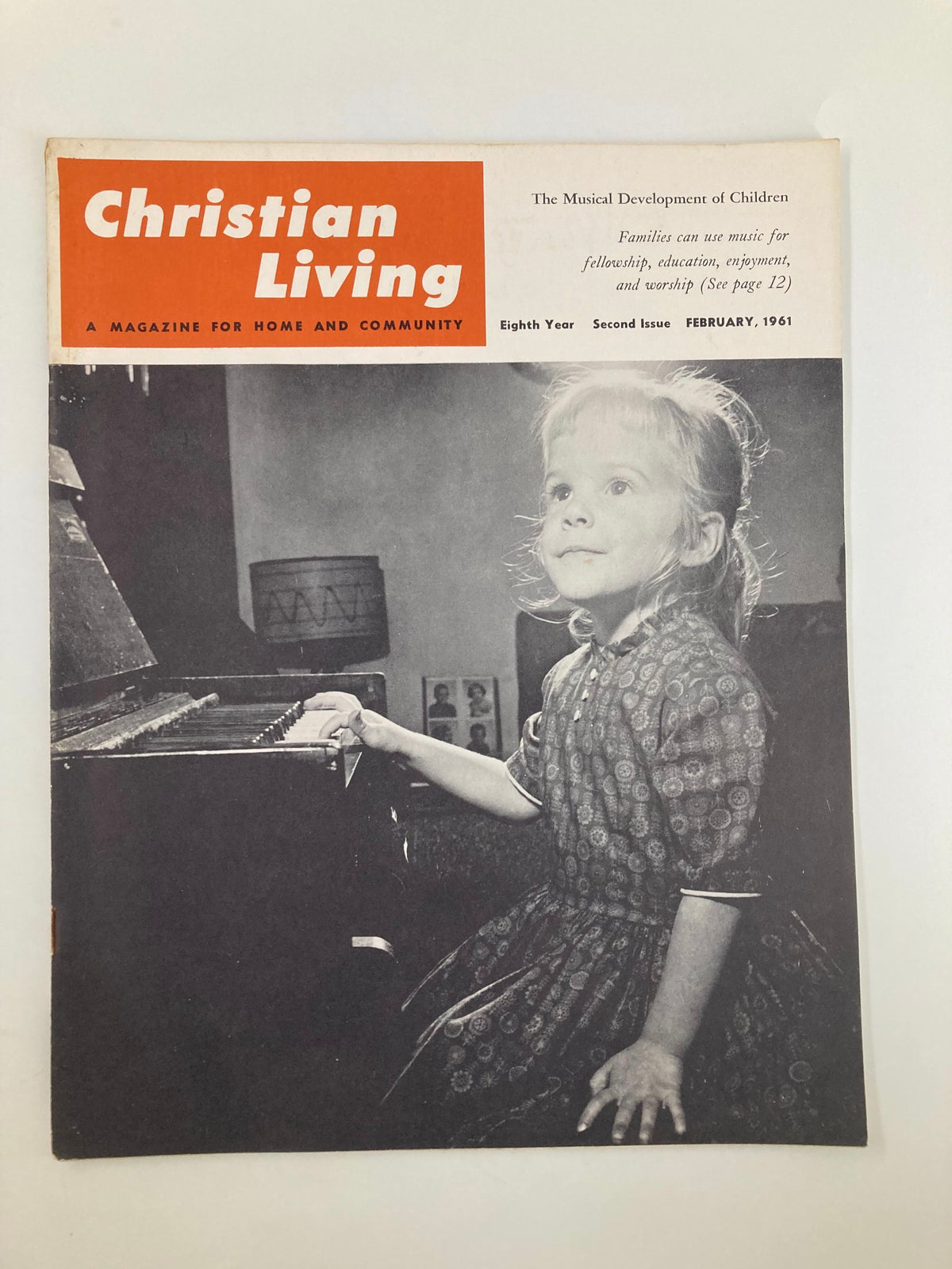 Cover of VTG Christian Living Magazine February 1961 featuring a young girl at a piano, illustrating 'The Musical Development of Children' theme.