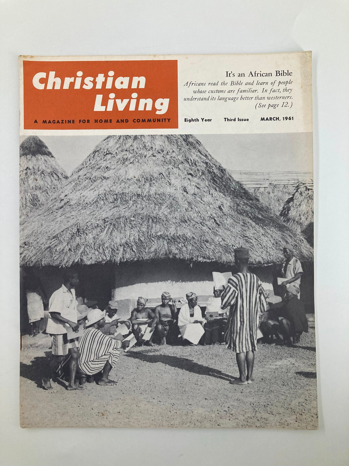 Vintage Christian Living Magazine March 1961 cover featuring the headline 'It's An African Bible in a Village' with a photograph depicting a group of African individuals gathered outside a thatched-roof structure.