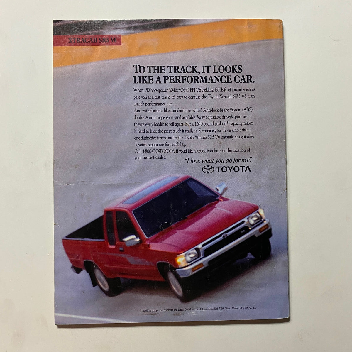 Toyota advertisement from Omni Magazine December 1991 Vol 14 No. 3 featuring the Toyota Xtracab SR5 V6 pickup truck with performance highlights.