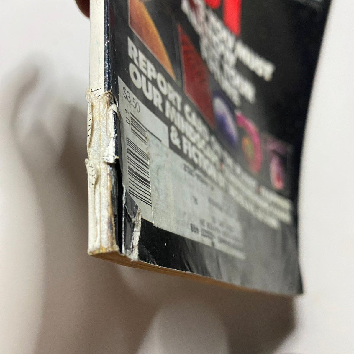 Side view of Omni Magazine January 1992 Vol 14 No. 4, showing wear on the spine and showcasing the magazine's vintage condition. A collectible item featuring insights into the future.