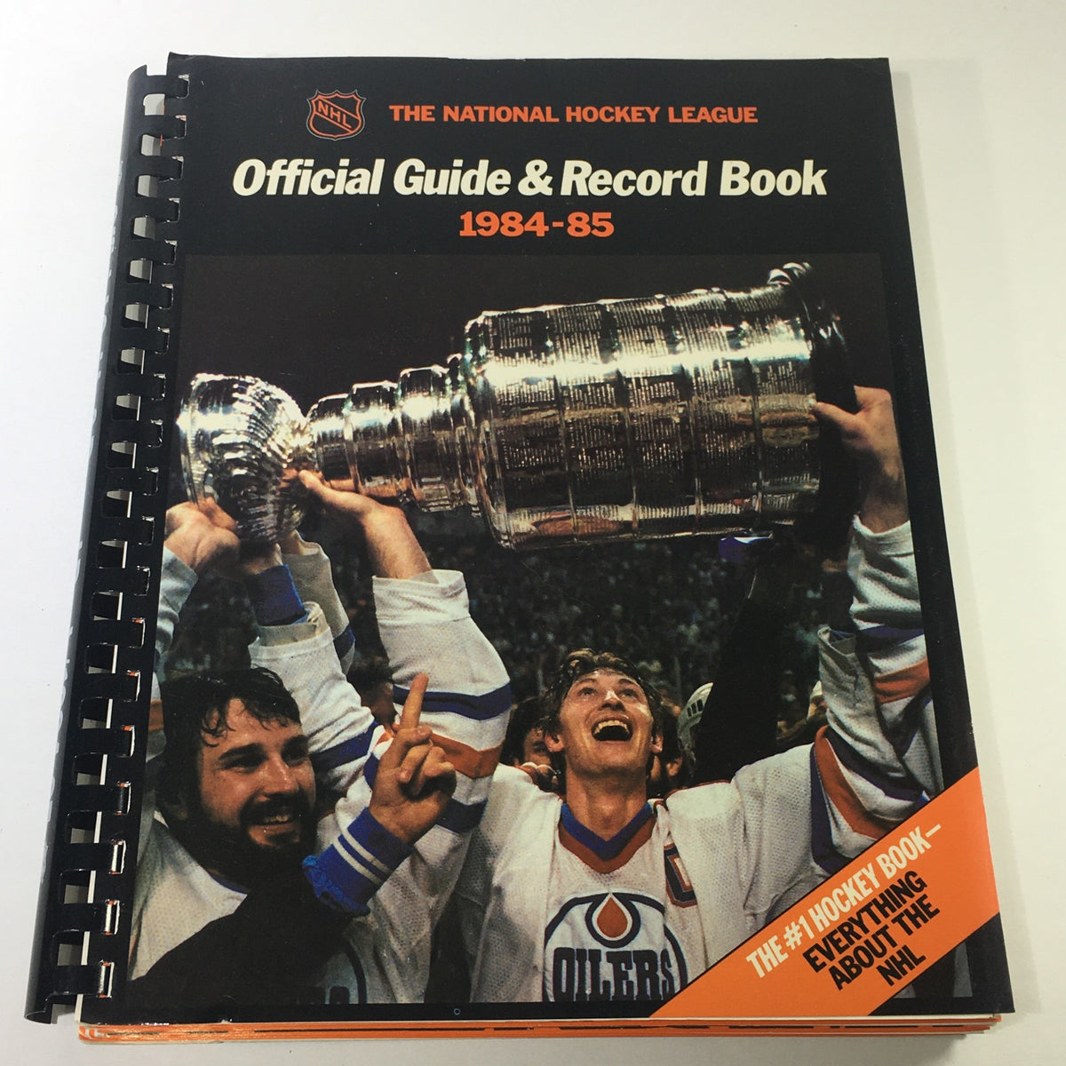 VTG NHL Official Guide & Record Book 1984-1985 featuring Edmonton Oilers cover, showcasing players celebrating with the Stanley Cup.