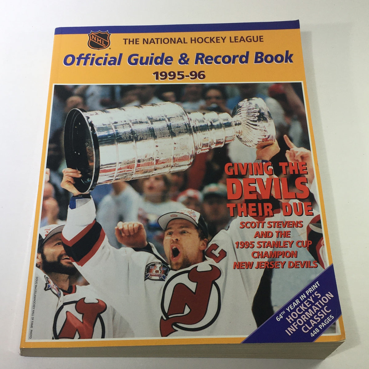 Cover of VTG NHL Official Guide & Record Book 1995-1996 featuring Scott Stevens and the New Jersey Devils celebrating their Stanley Cup victory.