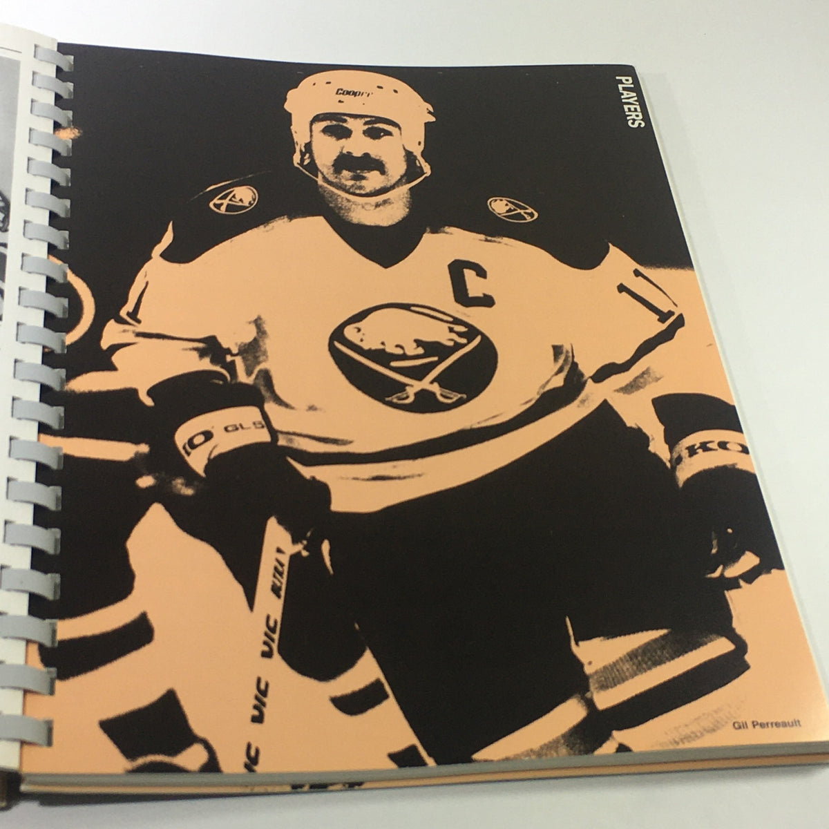 VTG NHL Official Guide & Record Book 1985-1986 Edmonton Oilers featuring player Gil Perreault in classic black and orange design, capturing a moment in hockey history.