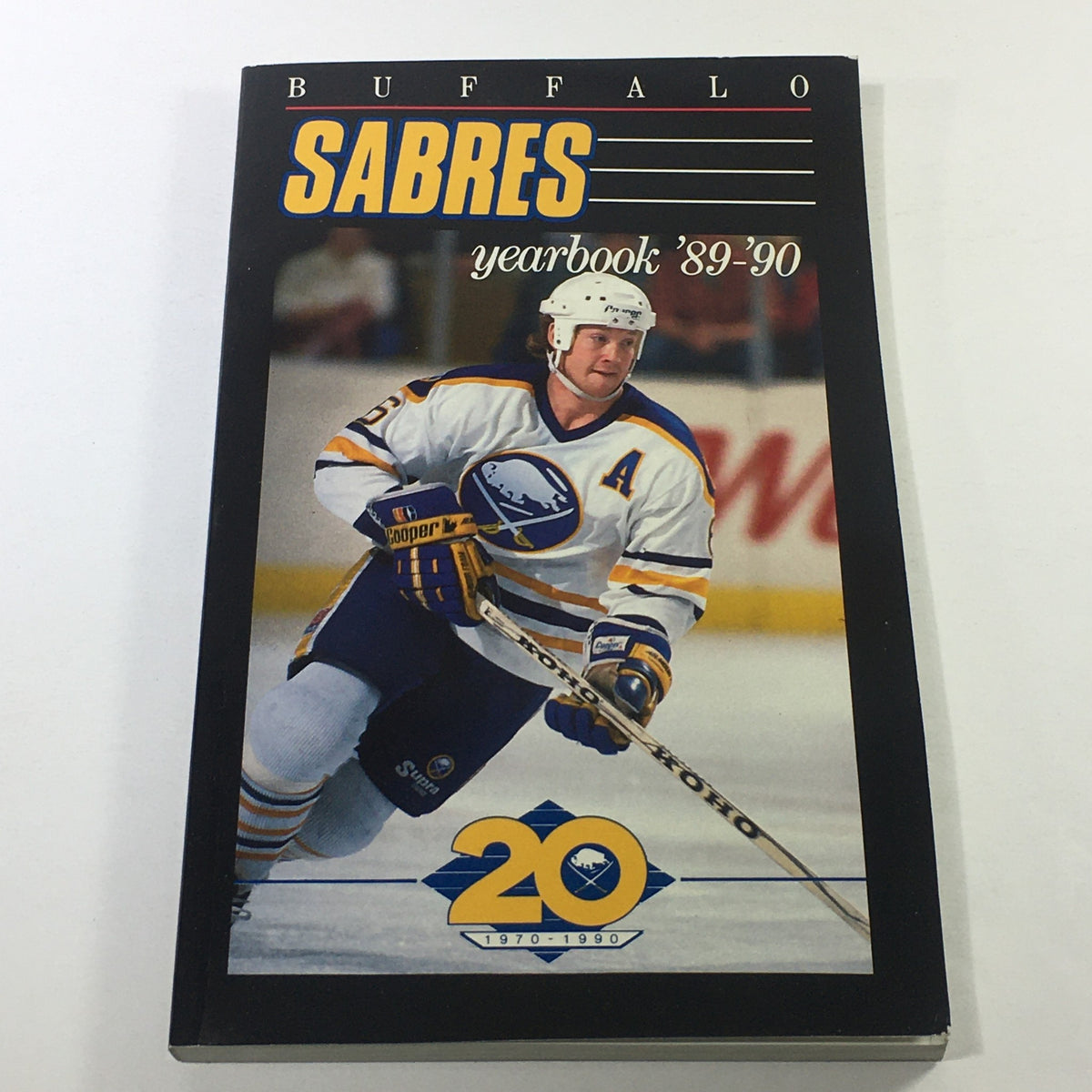 VTG NHL Official Yearbook 1989-1990 - Buffalo Sabres featuring Phil Housley, showcasing the cover design with the team logo and a player in action.