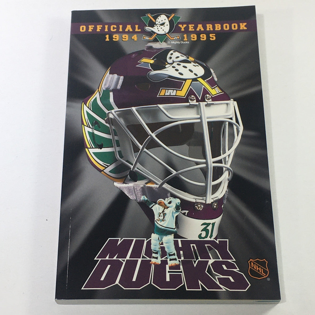 VTG NHL Official Yearbook 1994-1995 featuring the Mighty Ducks of Anaheim and player Guy Hebert, showcasing a colorful cover design with a hockey mask and team graphics.