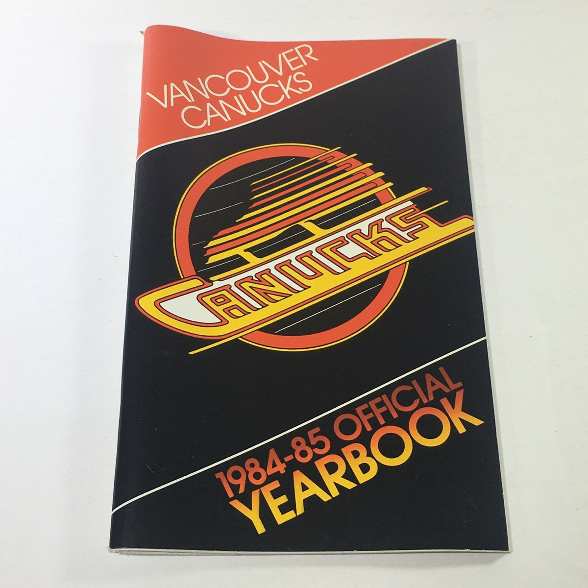 VTG NHL Official Yearbook 1984-1985 featuring the Vancouver Canucks Skate Logo on the cover, showcasing the team's branding and historic design.