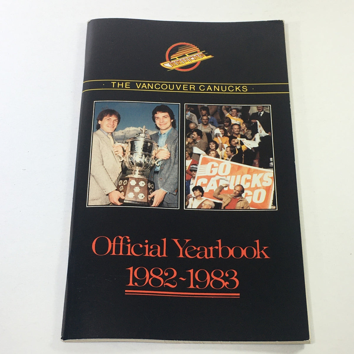 VTG NHL Official Yearbook 1982-1983 - Vancouver Canucks - Cover with images of players celebrating a championship trophy and fans supporting the team.