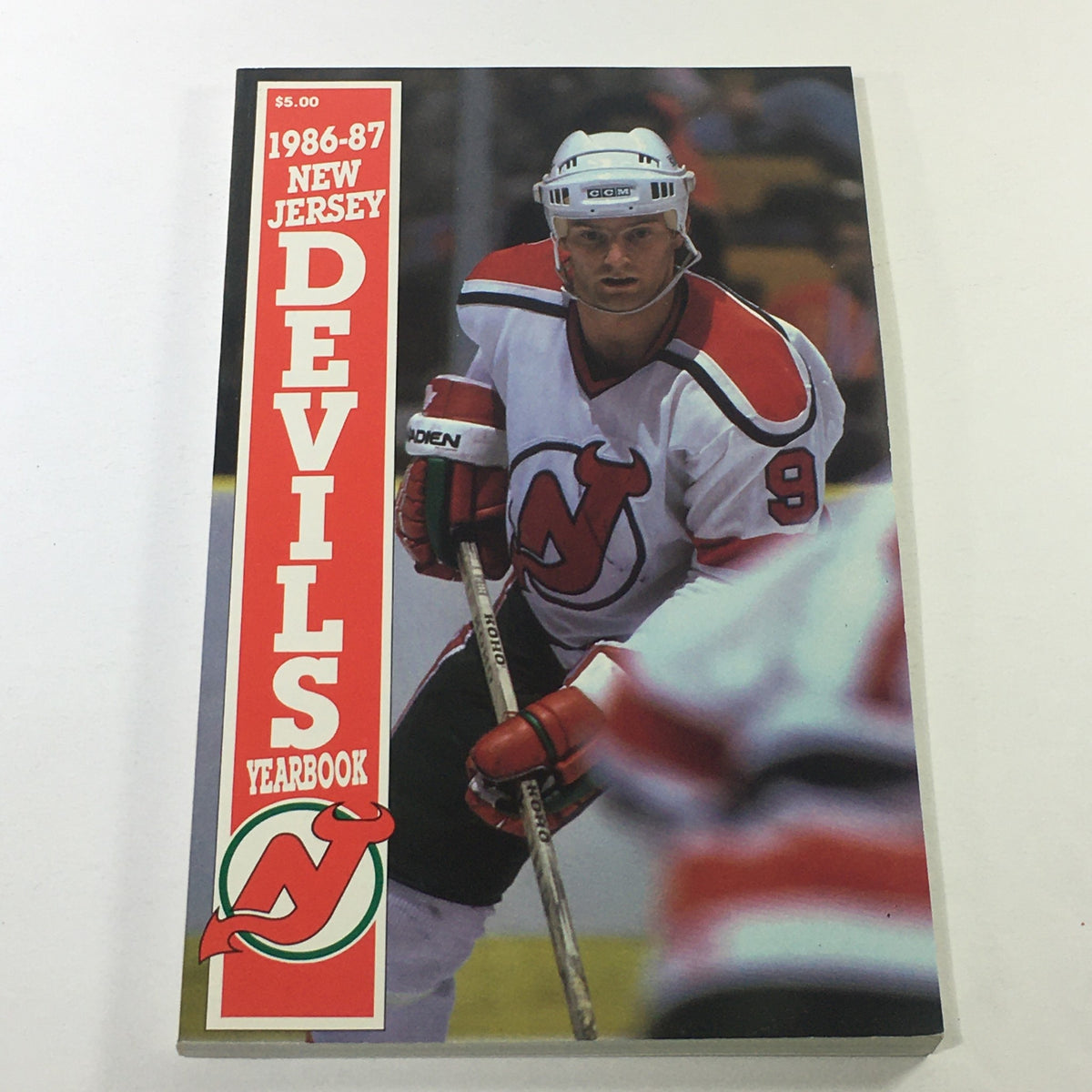 VTG NHL Official Yearbook 1986-1987 featuring New Jersey Devils player Kirk Muller on the cover, showcasing vibrant colors and bold text.
