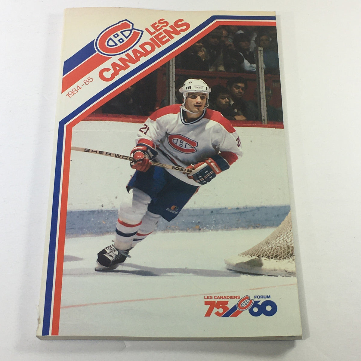 VTG NHL Official Guide 1984-1985 featuring Les Canadiens with player Guy Carbonneau on the cover, showcasing a dynamic image of Carbonneau in action during a hockey game.