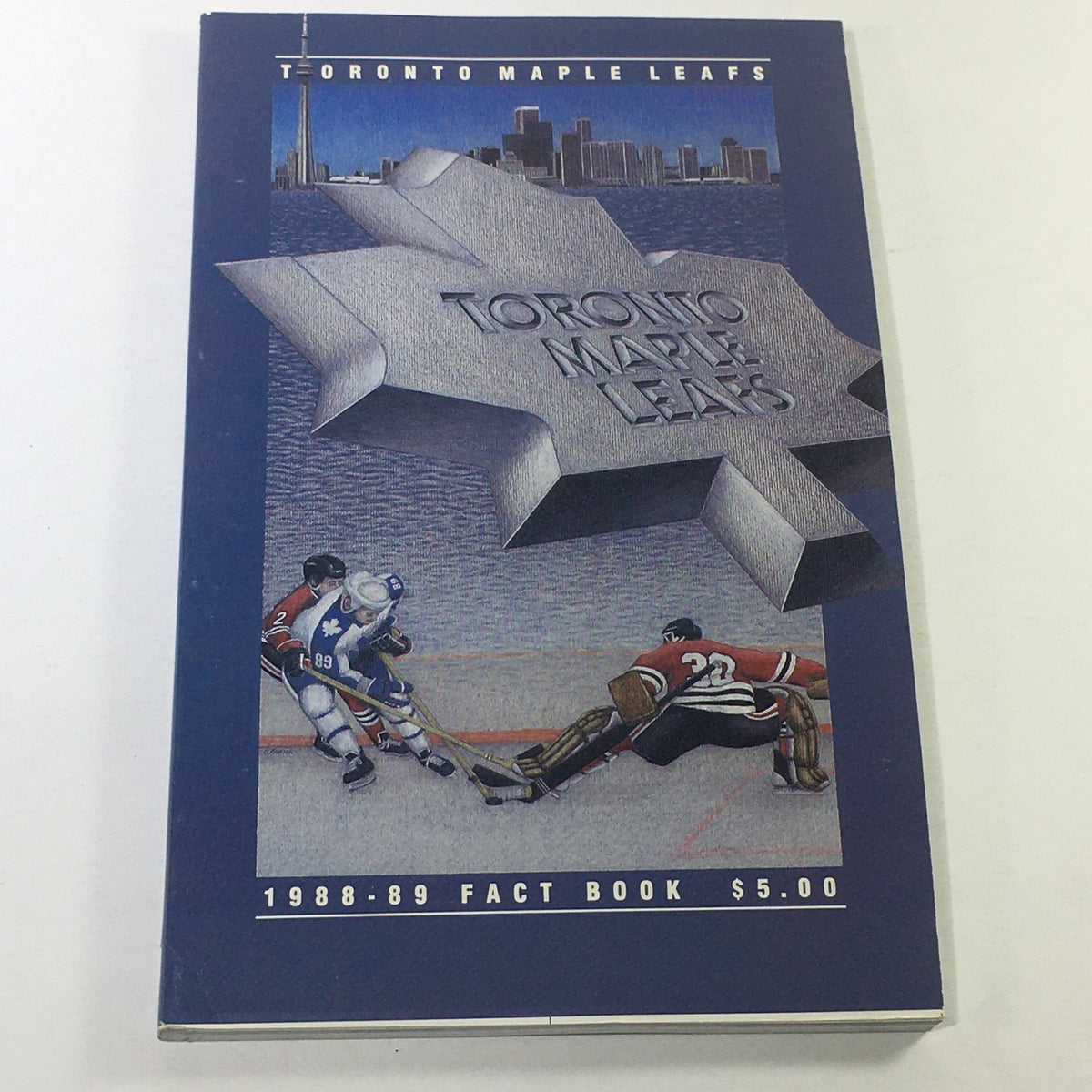 Cover of the VTG NHL Official Fact Books 1988-1989 - Toronto Maple Leafs featuring a hockey scene with Toronto's skyline in the background.