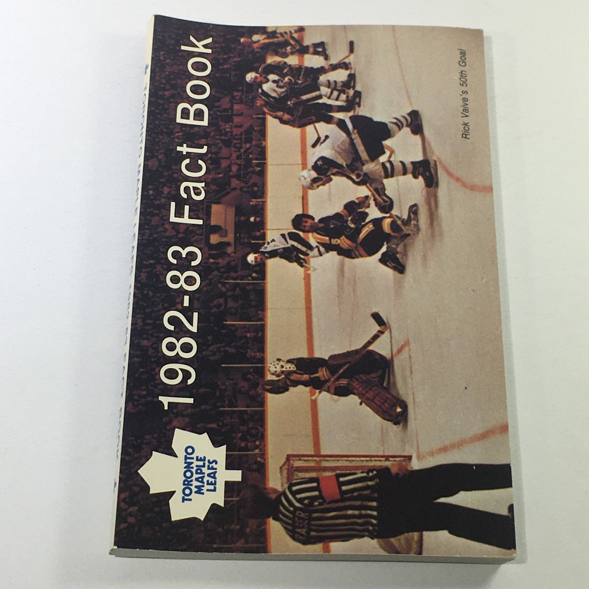 Cover of VTG NHL Official Fact Book 1982-1983 featuring the Toronto Maple Leafs and goalie Rick Vaive on the ice, depicting a vintage hockey scene.