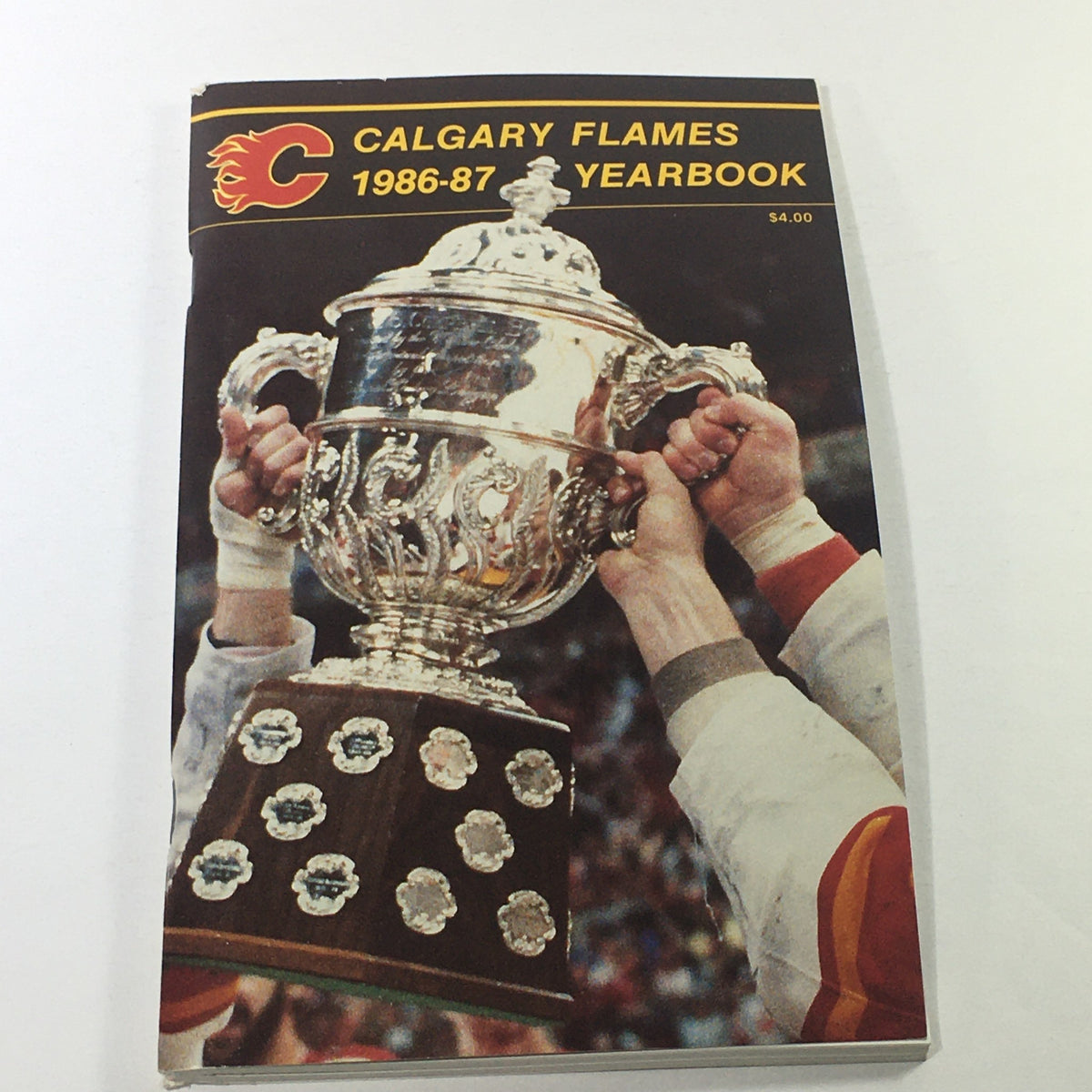 VTG NHL Official Yearbook 1986-1987 featuring the Calgary Flames celebrating with the trophy, highlighting the impressive Molson Cup victory.