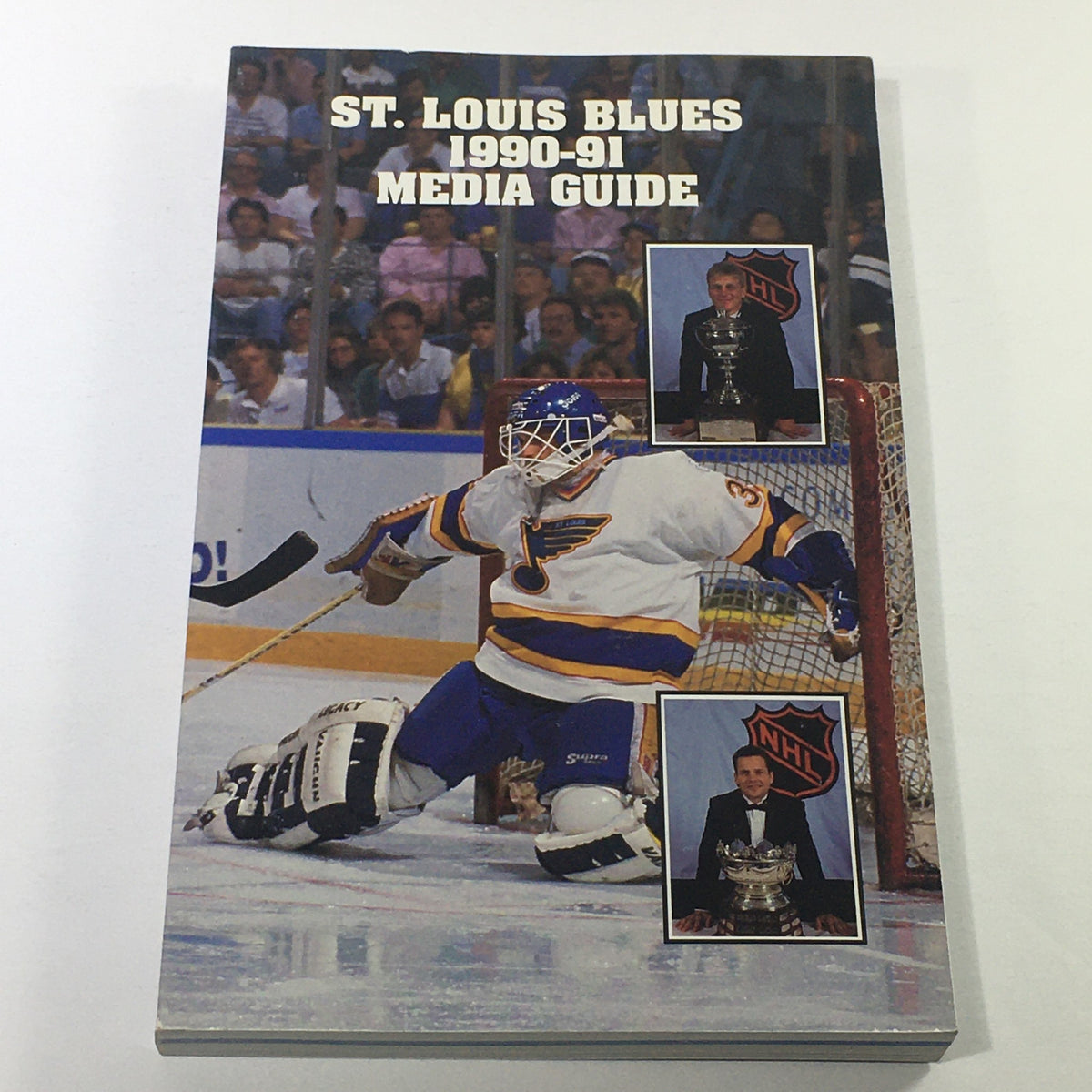 VTG NHL Official Media Guide 1990-1991 - St. Louis Blues featuring a goalie in action on the cover, showcasing team spirit and memorabilia.