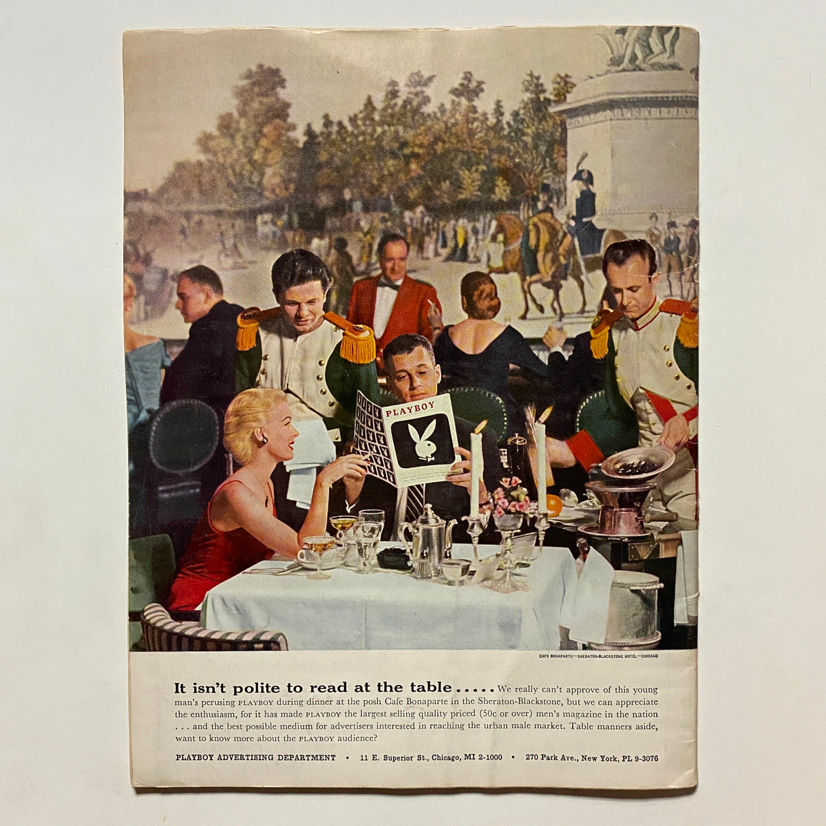 Back cover of VTG Playboy Magazine September 1956 displaying a colorful dining scene with a couple enjoying the magazine at the table, illustrating the magazine's cultural impact.