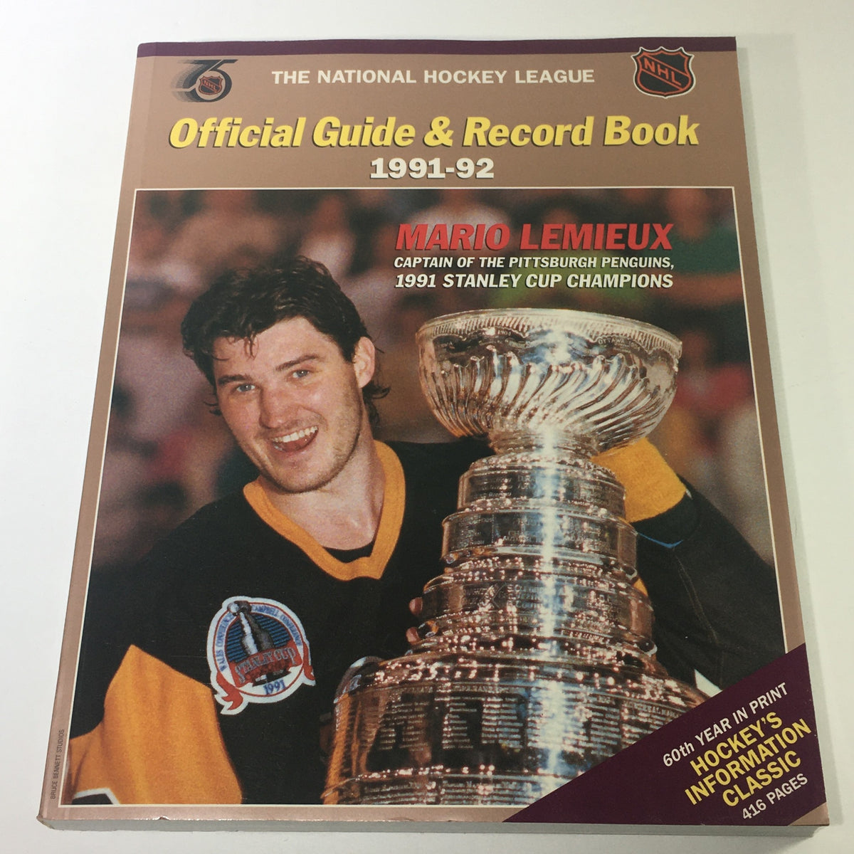 VTG NHL Official Guide & Record Book 1991-1992 featuring Mario Lemieux celebrating with the Stanley Cup, highlighting his role as captain of the Pittsburgh Penguins during the 1991 championships.