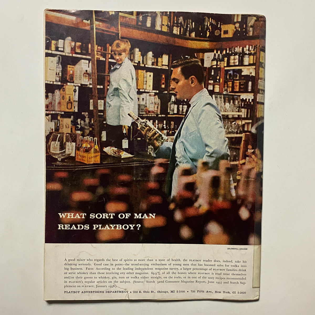 Back cover of Vintage Playboy Magazine August 1958 featuring a vintage advertisement with two men in a liquor store, adding historical context to the publication.