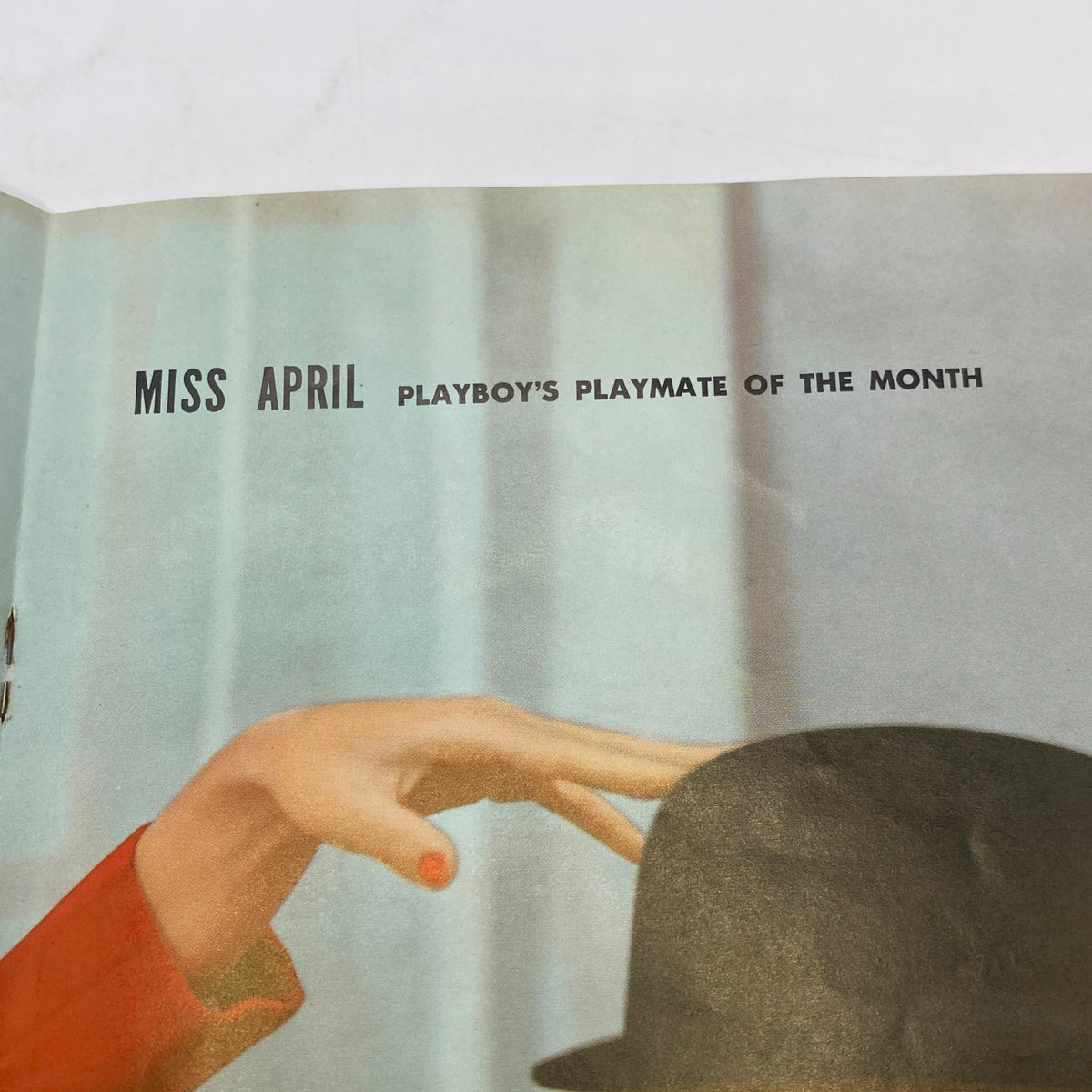 Inside page of VTG Playboy Magazine April 1959 highlighting Miss April, Playmate of the Month, showcasing a stylish hand and hat.
